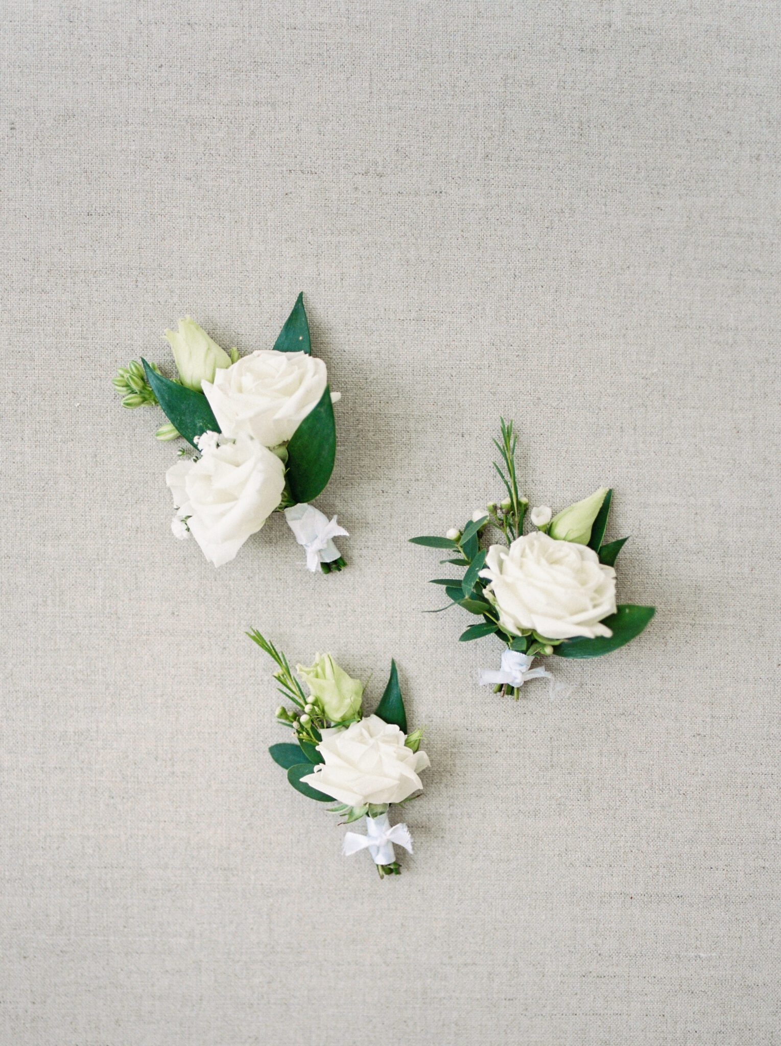Classic white rose boutonniere’s from Lovella Lifestyle.