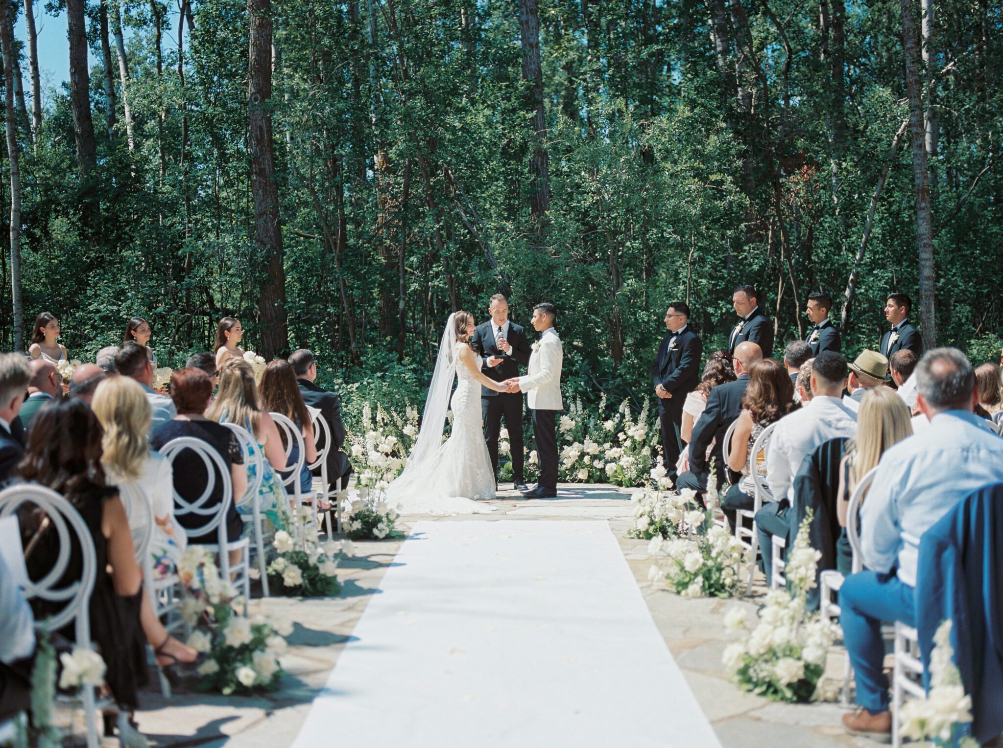 Elegant wedding ceremony at Sparrow Lane Events in Alberta. Classic colour palette of white, blush, and green wedding inspiration. 