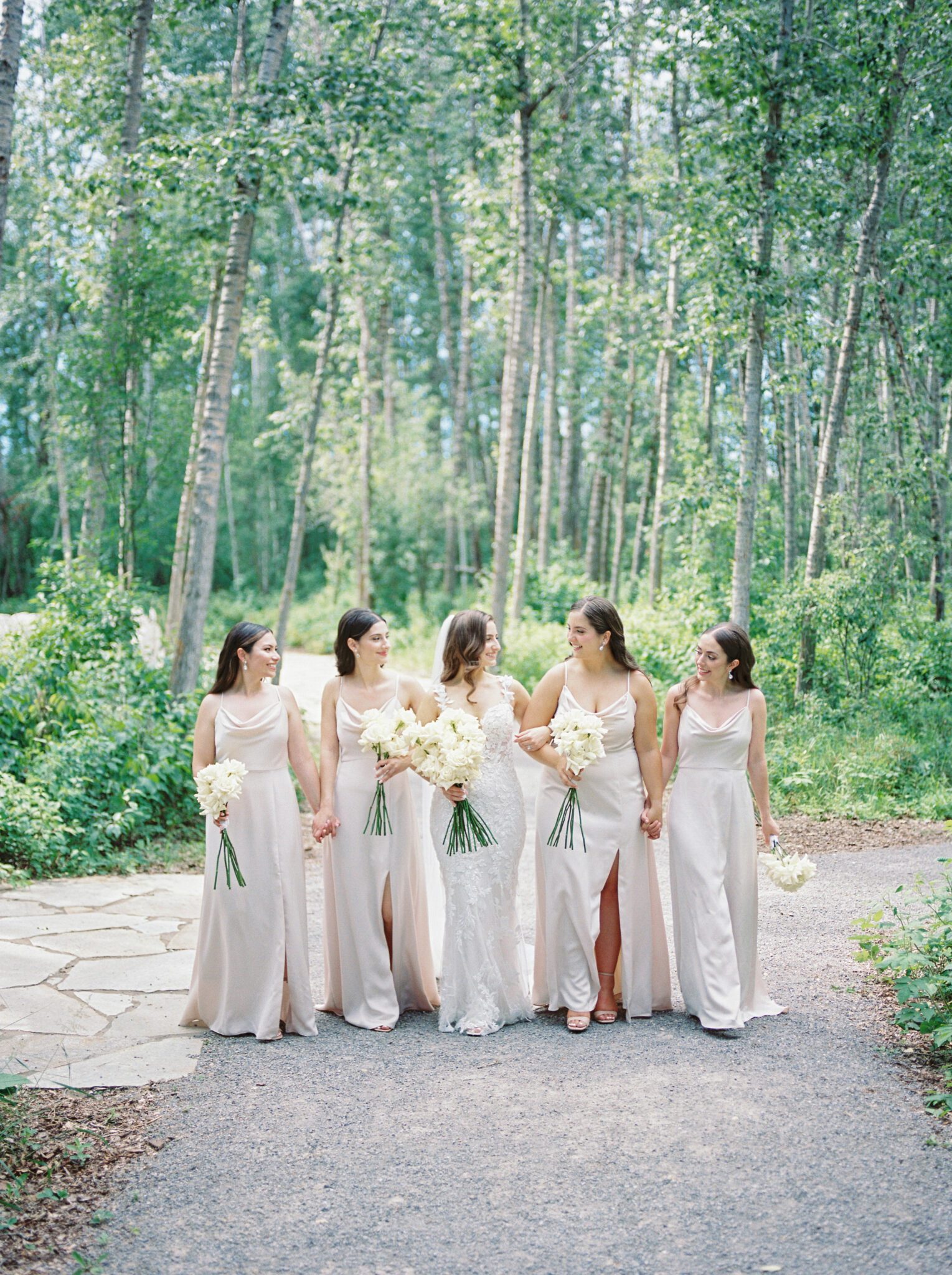 Elegant wedding party outside of Sparrow Lane Events in Alberta. Classic colour palette of white, blush, and green wedding inspiration.