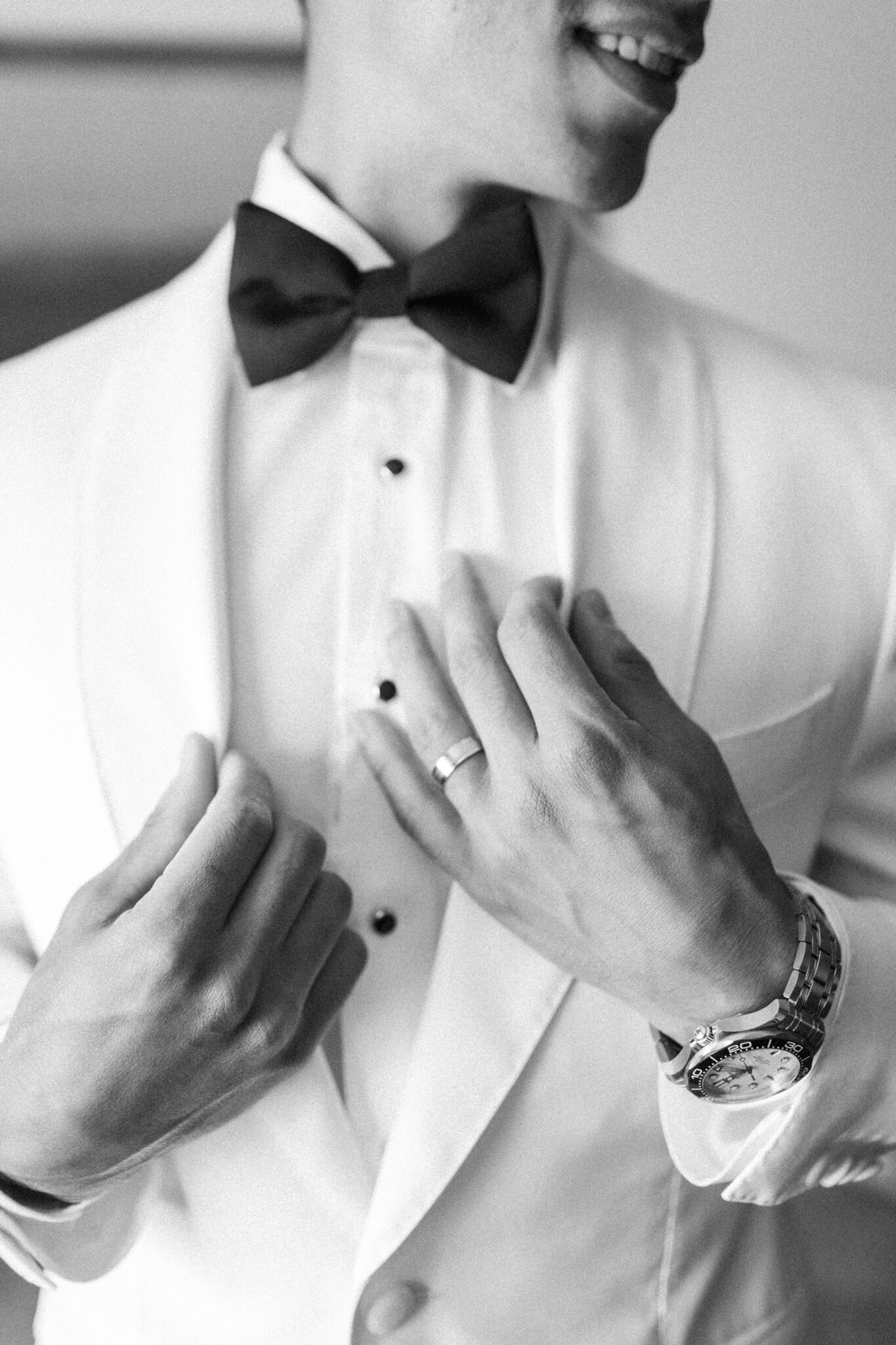 Groom getting ready on his wedding day at Sparrowlane Events. Elegant wedding inspiration. Classy white tux jacket and black pants by Atelier Suiting.