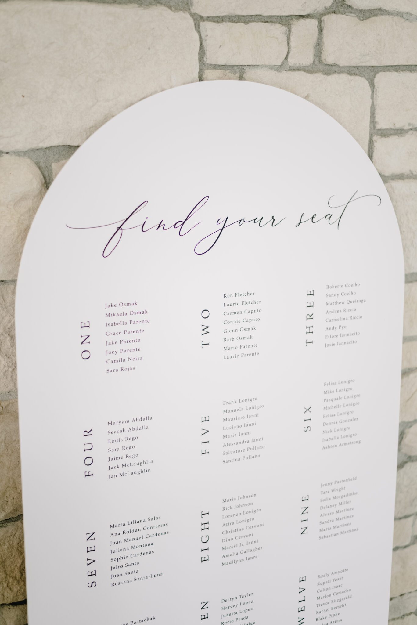 White and black wedding reception seating chart. Elegant summer wedding reception at Sparrow Lane Events in Alberta. Summer wedding features white roses, greenery blush decor accents and warm wood tones.