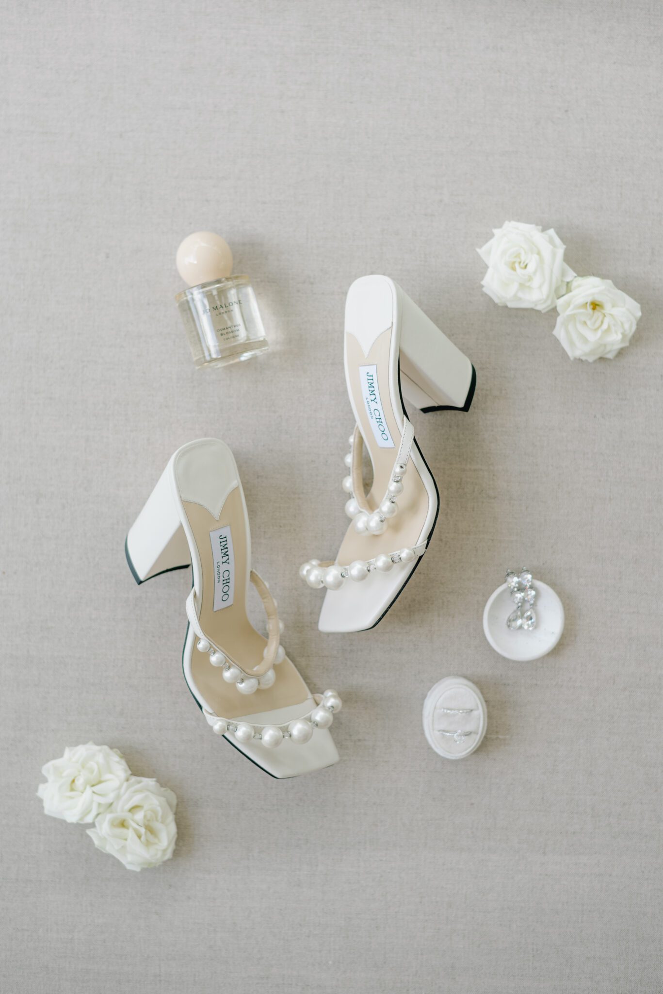 Classic and elegant bridal details featuring Jimmy Choo shoes with large pearl straps, Jo Malone perfume captured by Jenny Jean Photography.