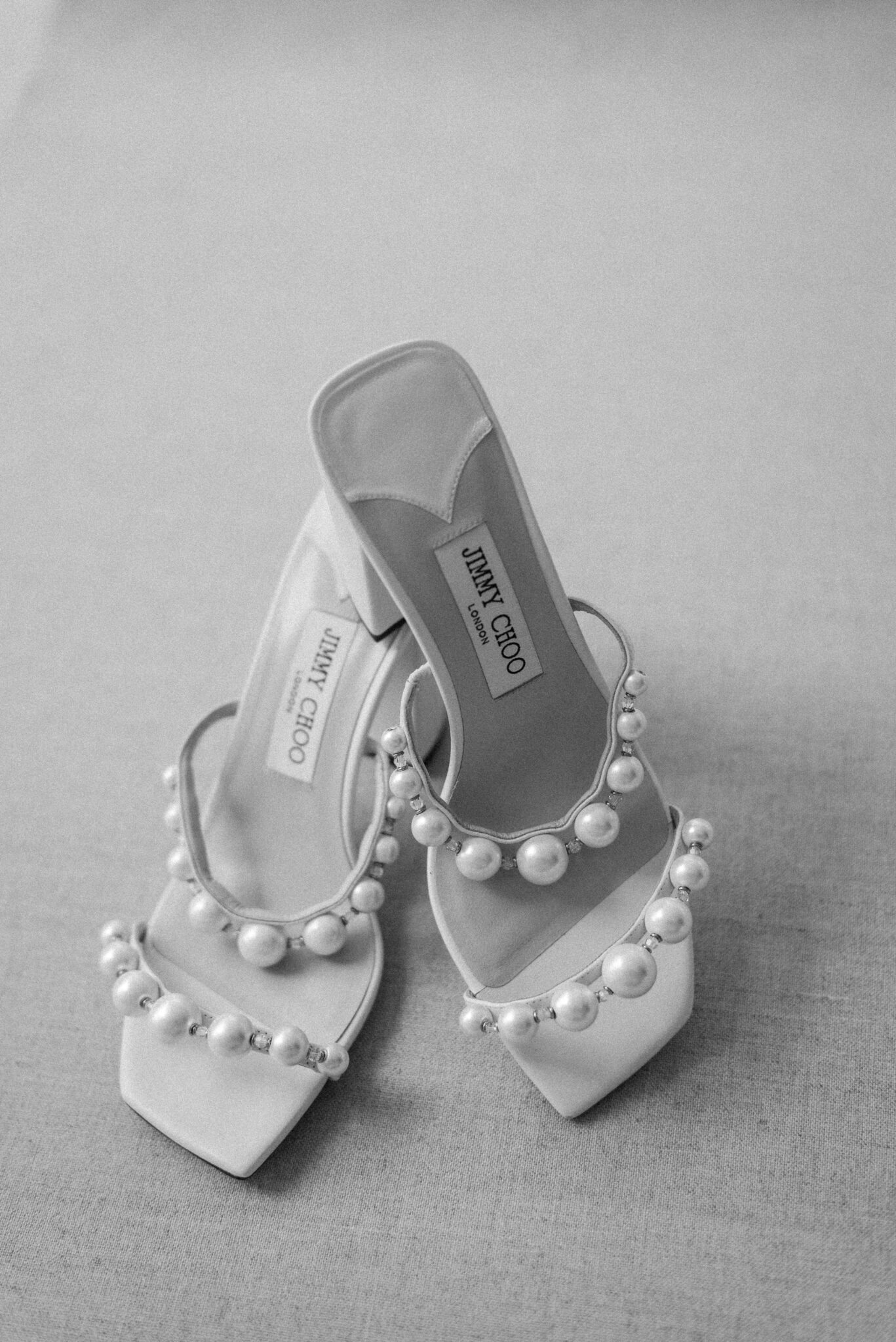 Classic and elegant bridal details featuring Jimmy Choo shoes with large pearl straps captured by Jenny Jean Photography.