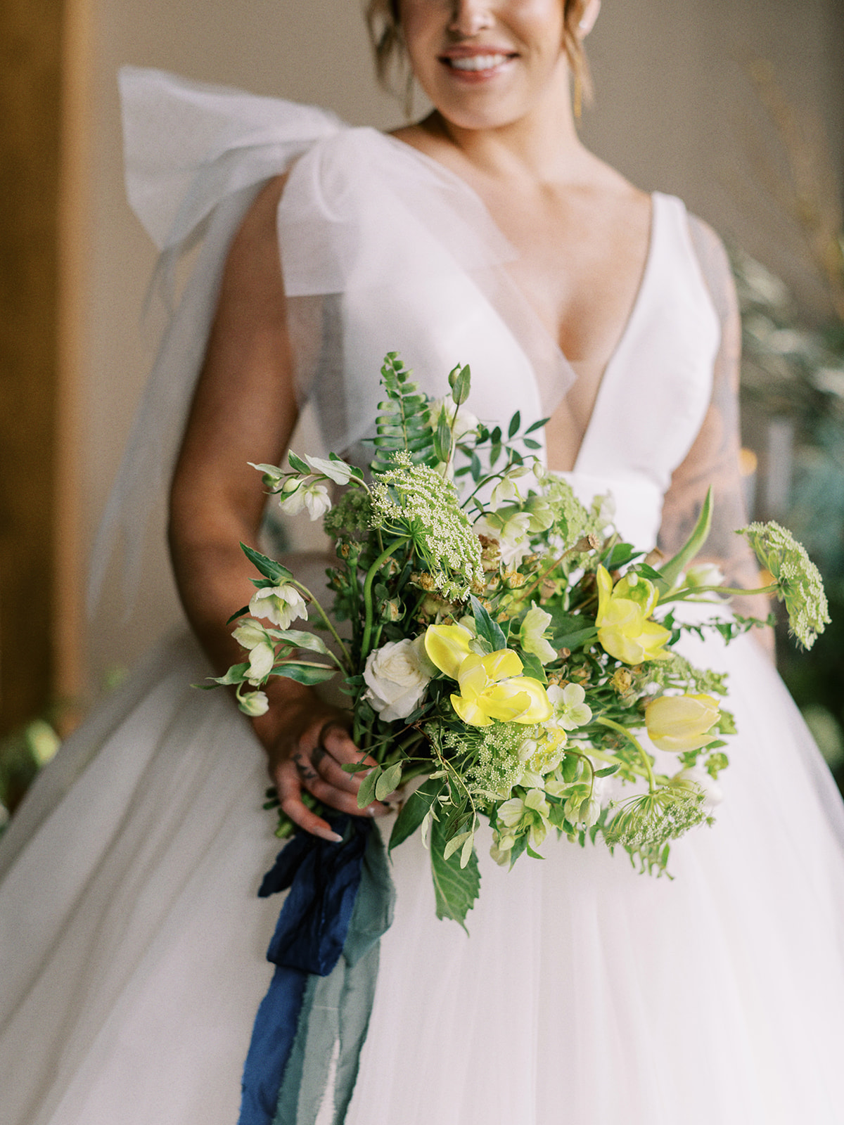 Stunning organic yellow and blue bridal bouquet by Hue Florals. Mediterranean-Inspired wedding at The Malcolm Hotel in Canmore, Alberta. 