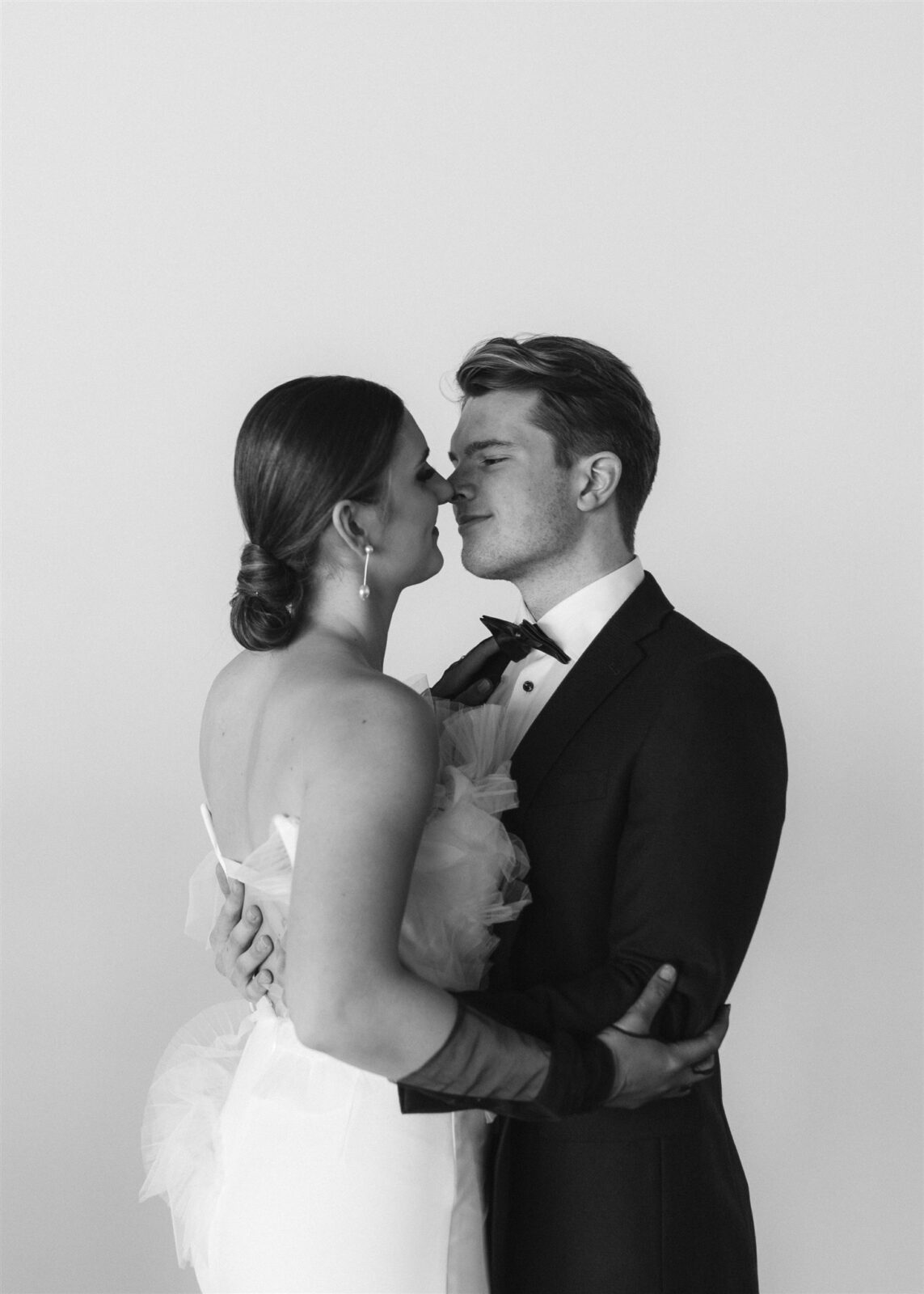 Couple embracing during sophisticated and minimalist wedding at The Wallace Venue in Vancouver, BC. 