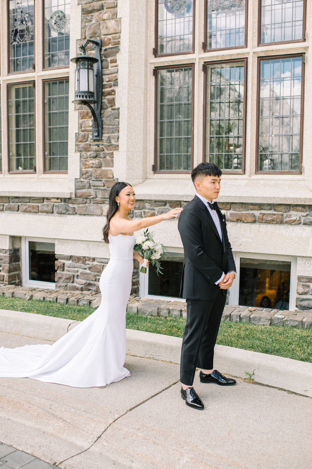 Elegant bride and groom first look outside of Fairmont Banff Springs Golf and Country Club.  Summer wedding inspiration. 