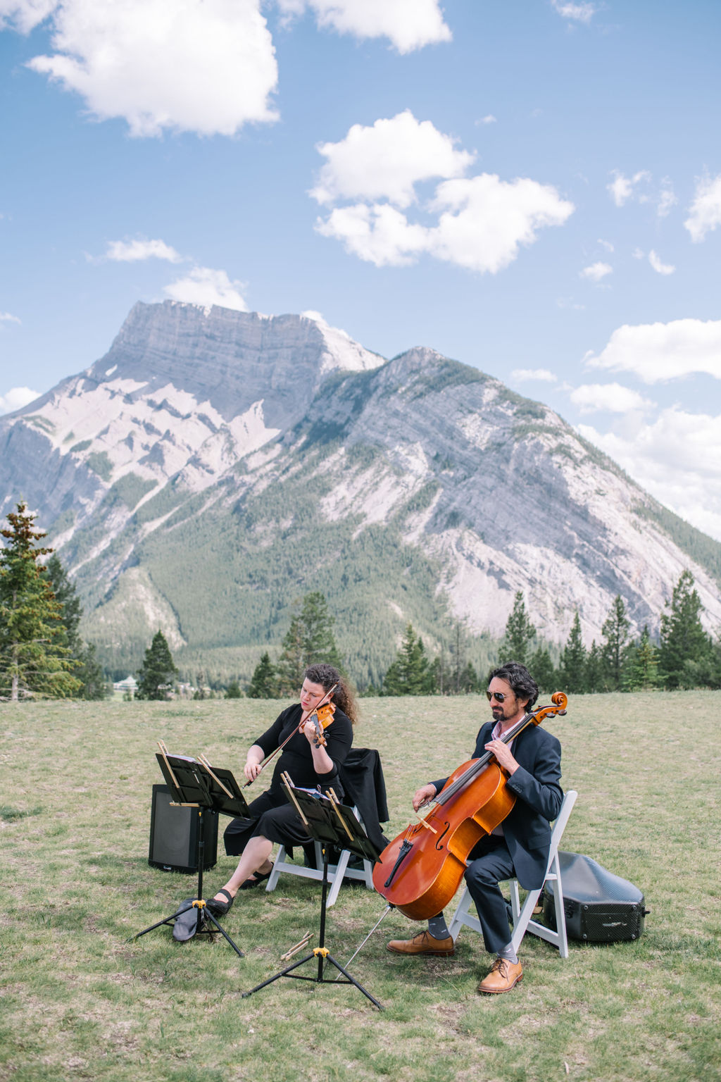Violin players during sophisticated mountain wedding in Banff, Alberta, Canada. Summer mountain wedding inspiration. 