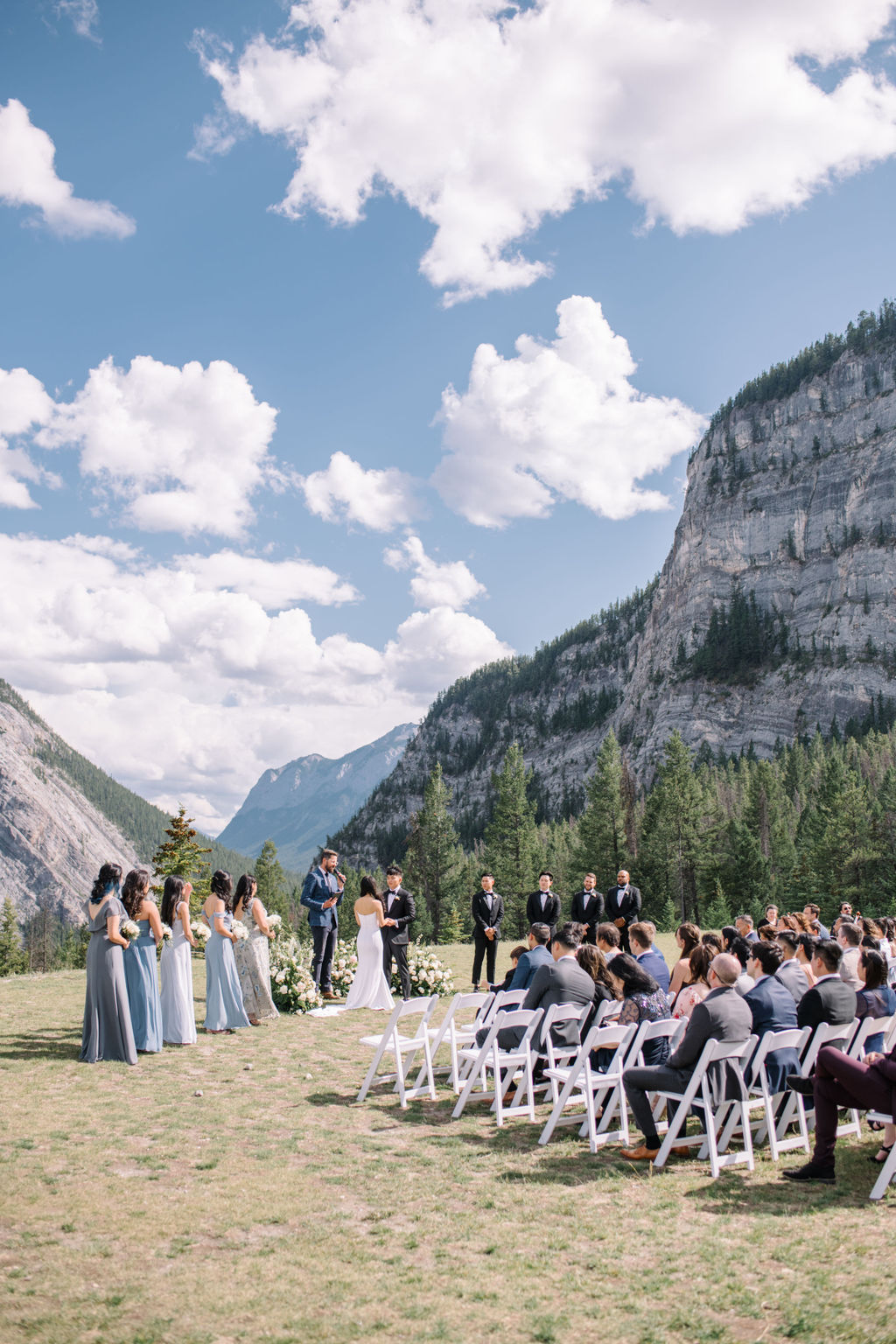 Bride and groom exchange vows during sophisticated mountain wedding in Banff, Alberta, Canada. Summer mountain wedding inspiration. 