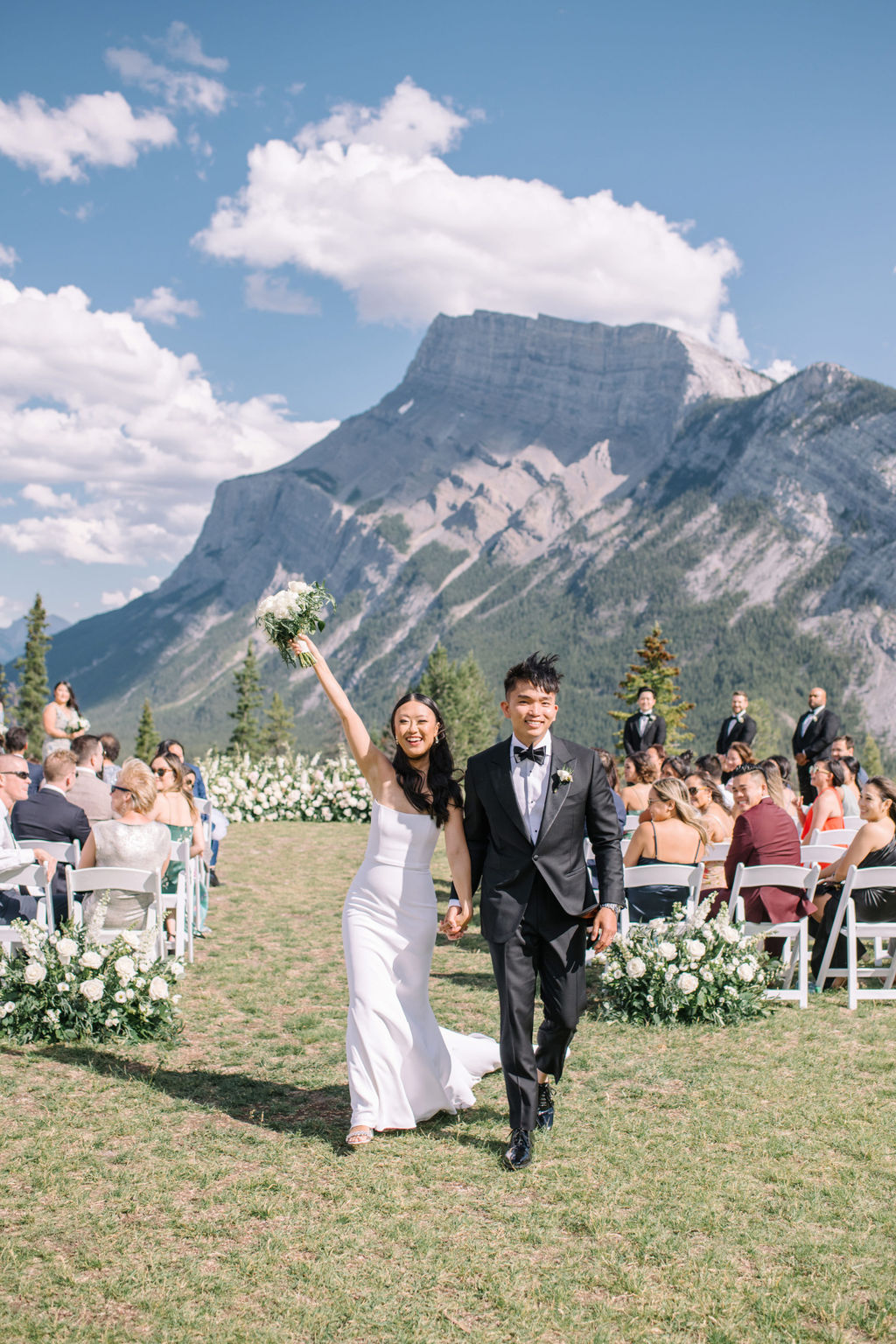 Bride and groom exit sophisticated mountain wedding ceremony in Banff, Alberta, Canada. Summer mountain wedding inspiration. 