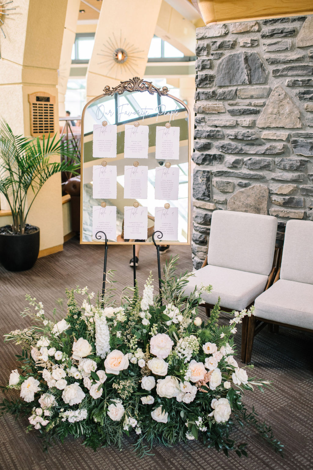 Wedding reception seating chart on gold antique style ornate mirror. Classically styled Fairmont Banff Springs wedding reception. 