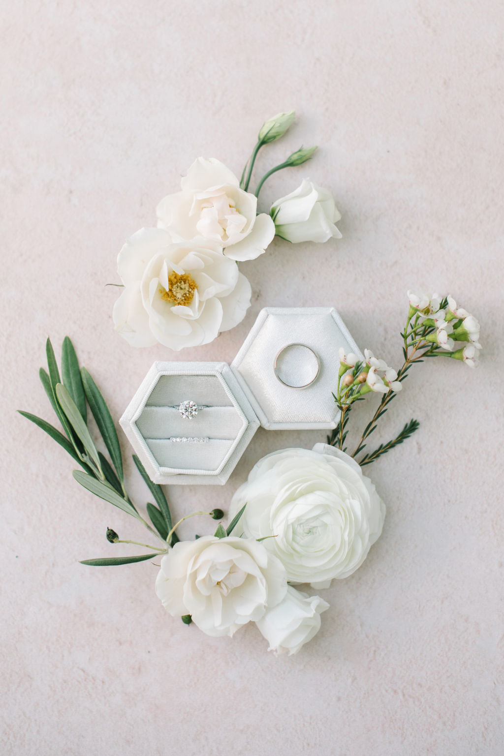 Elegant wedding rings in white hexagon ring box styled with white roses and greenery, Classic neutral, blush, cremes, dusty blue colour scheme, photographed by Corrina Walker Photography. 