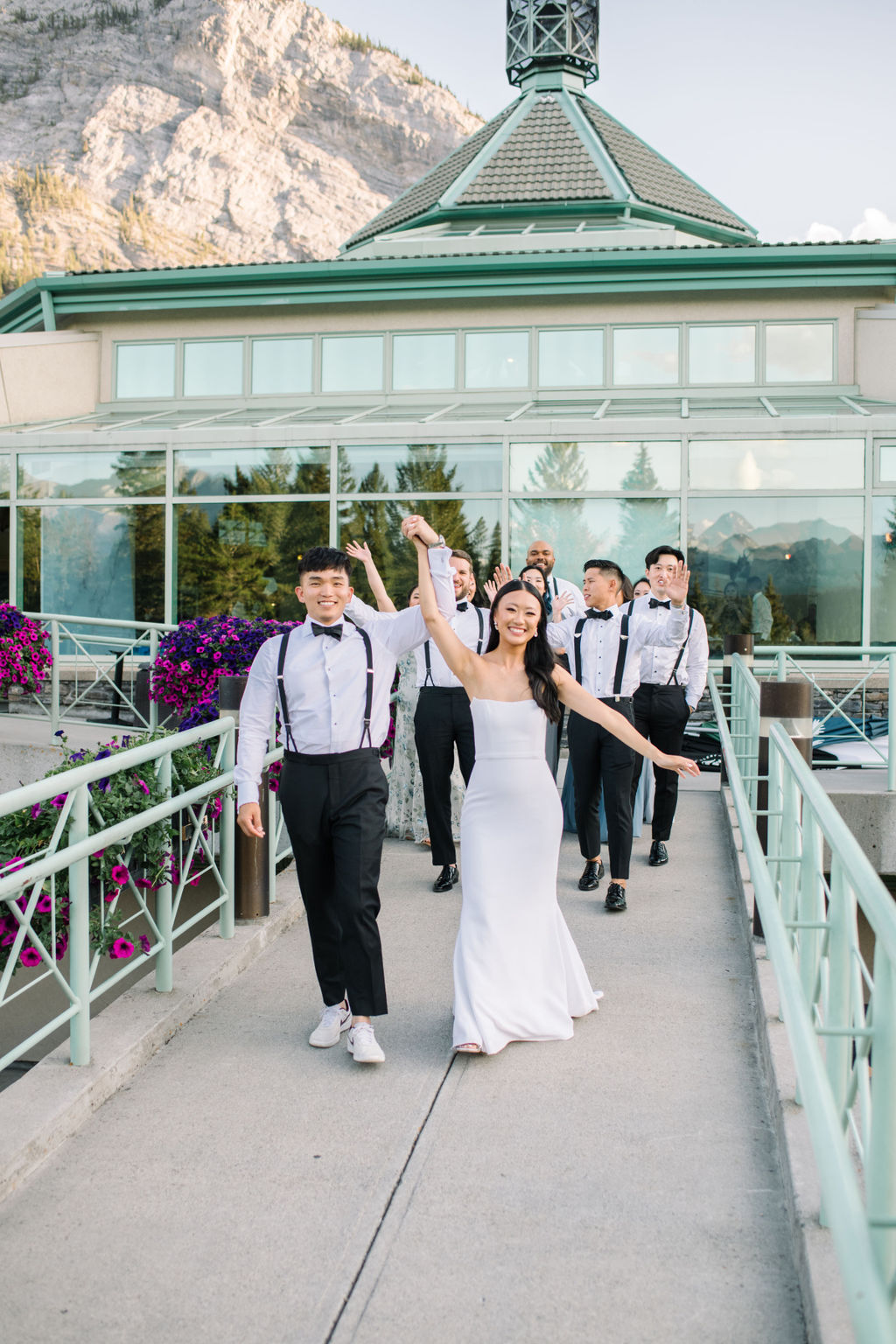 Bride and groom exiting wedding reception at Fairmont Banff Springs in Alberta, Canada. Summer mountain wedding inspiration. 
