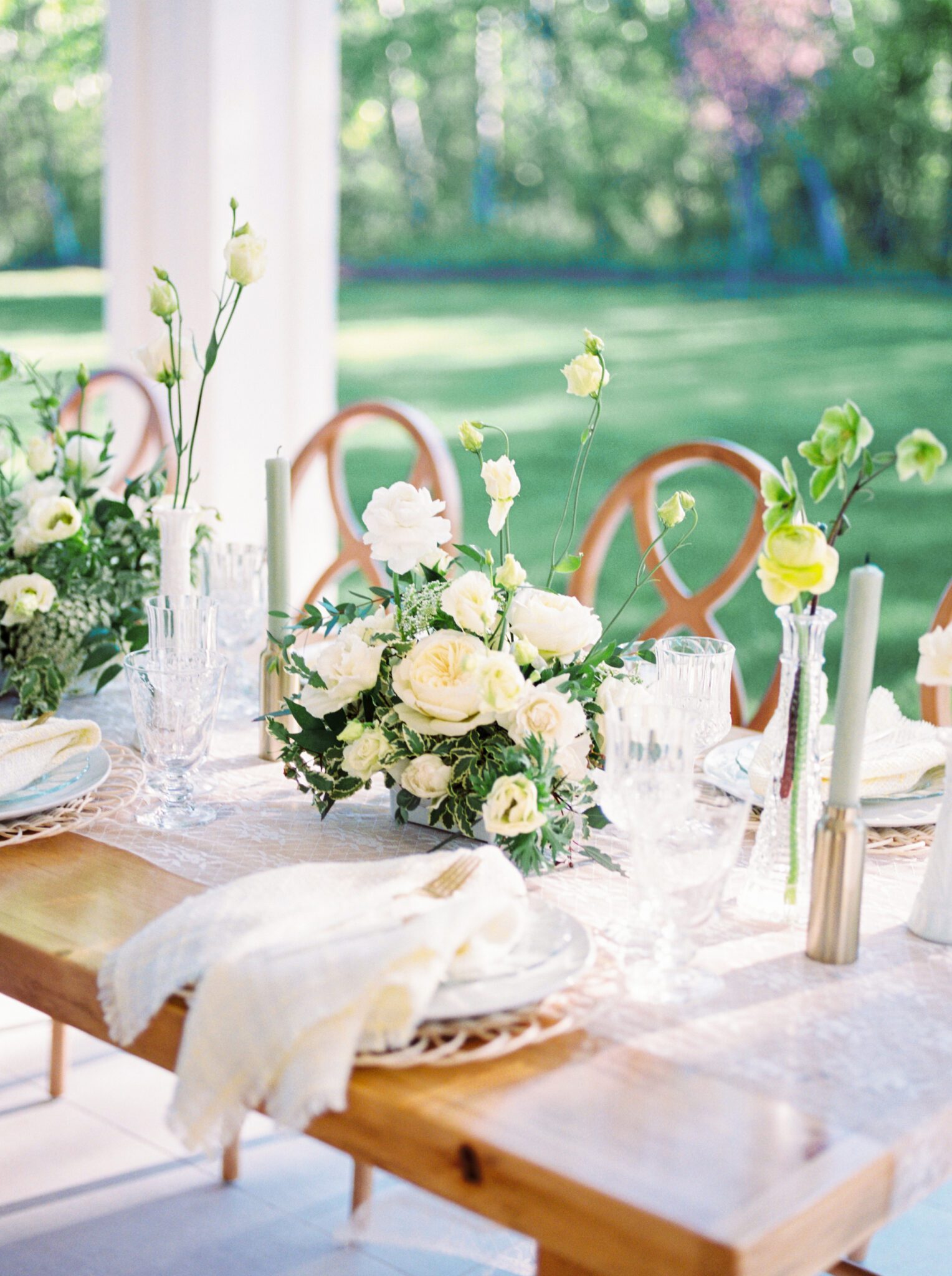 Cottage core inspired wedding reception at Sparrow Lane Weddings and Events venue near Edmonton, Alberta. Fine art summer wedding. Wooden infinity chairs, outdoor summer wedding tablescape with lush florals in pale yellow, ivory and white with greenery. 
