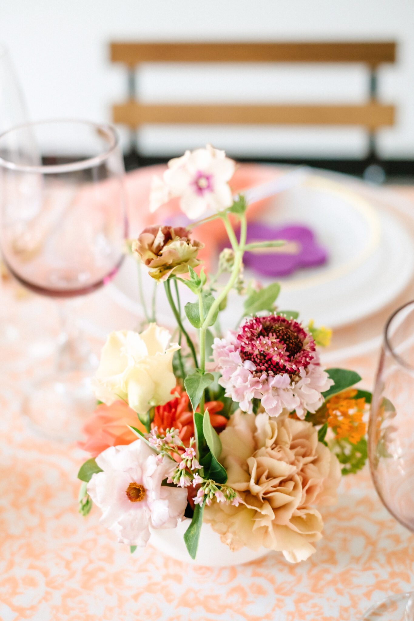 Bright & colourful floral reception table centerpiece by Meadow & Vine.