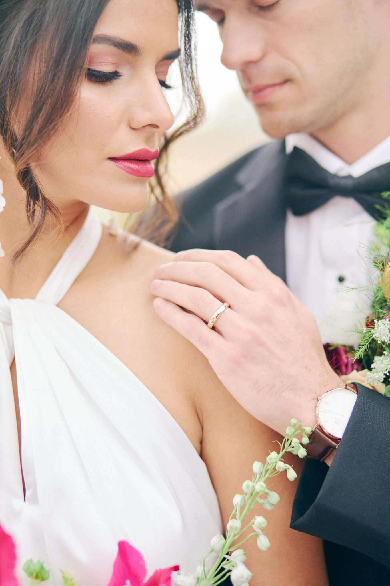 Elegant and modern bride wears a halter style wedding dress, and bold pink lipstick. Bridal fashion inspiration. 