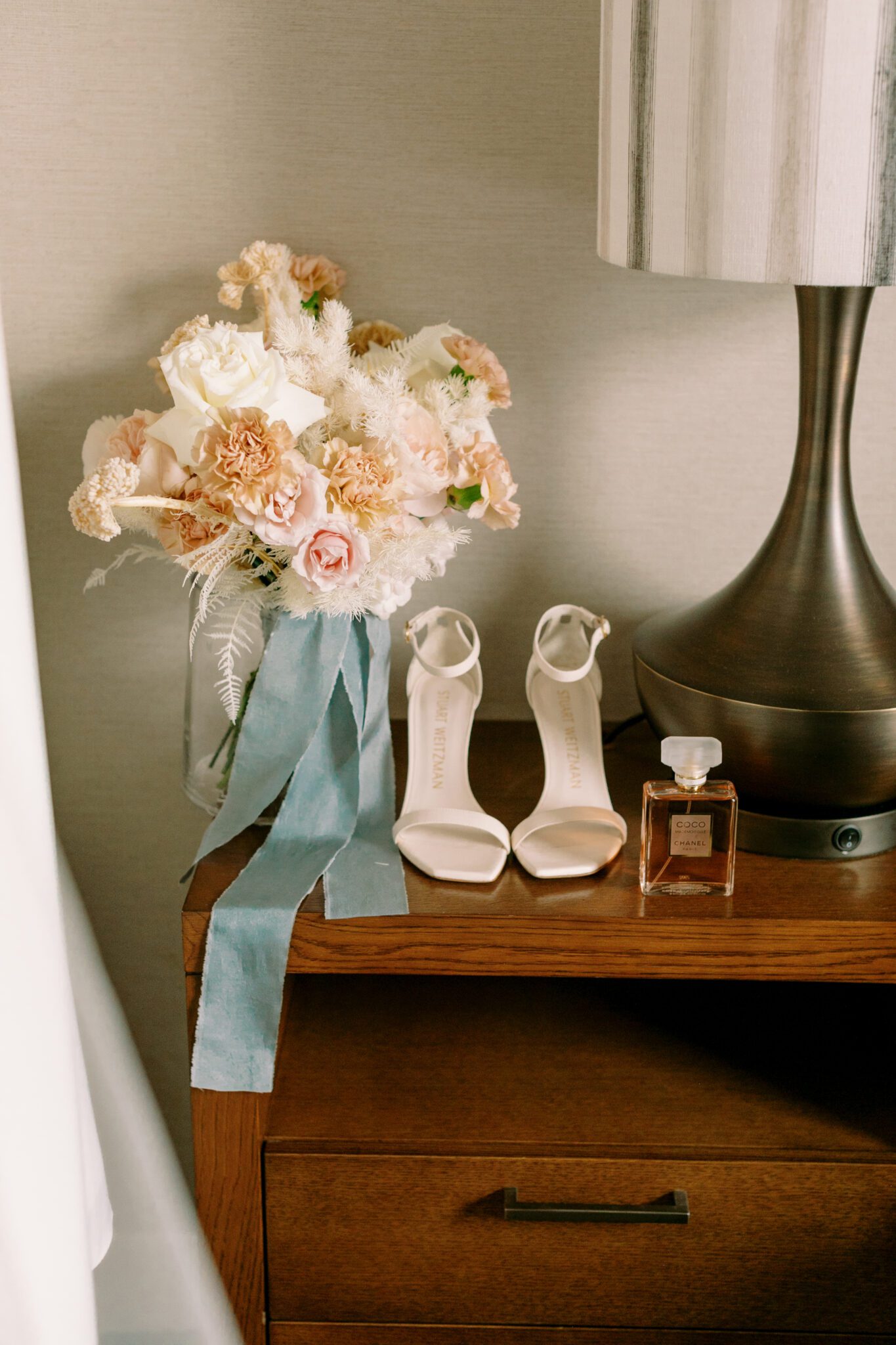 Brides getting ready wedding details at The Malcolm Hotel. Bridal bouquest of pink and peach tied with teal ribbon. Coco Chanel bridal perfume. 