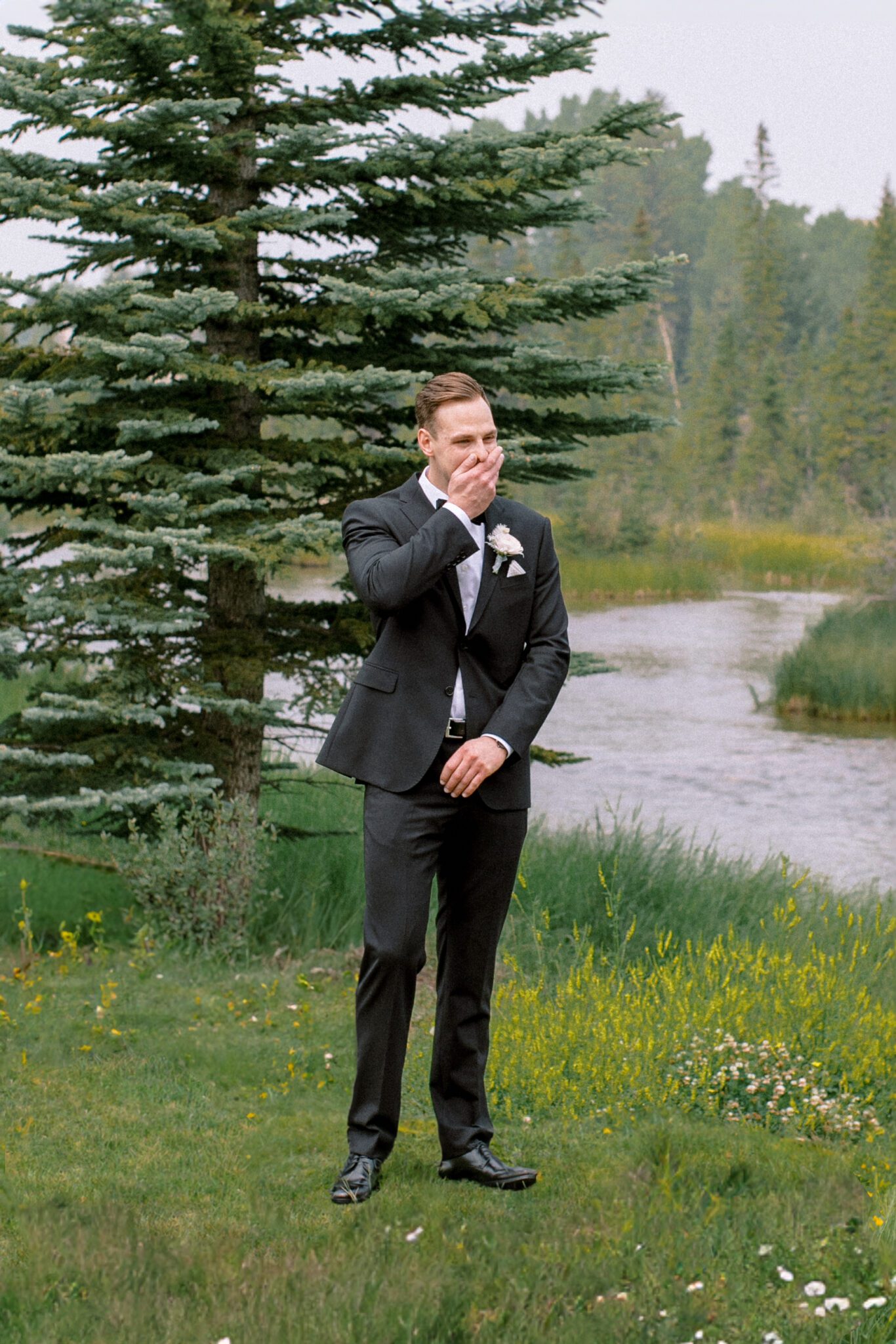 Bride and groom first look at Stewart Creek Golf Course in Canmore, Alberta. Wedding first look inspiration. Groom's reaction to seeing bride for the first time. 