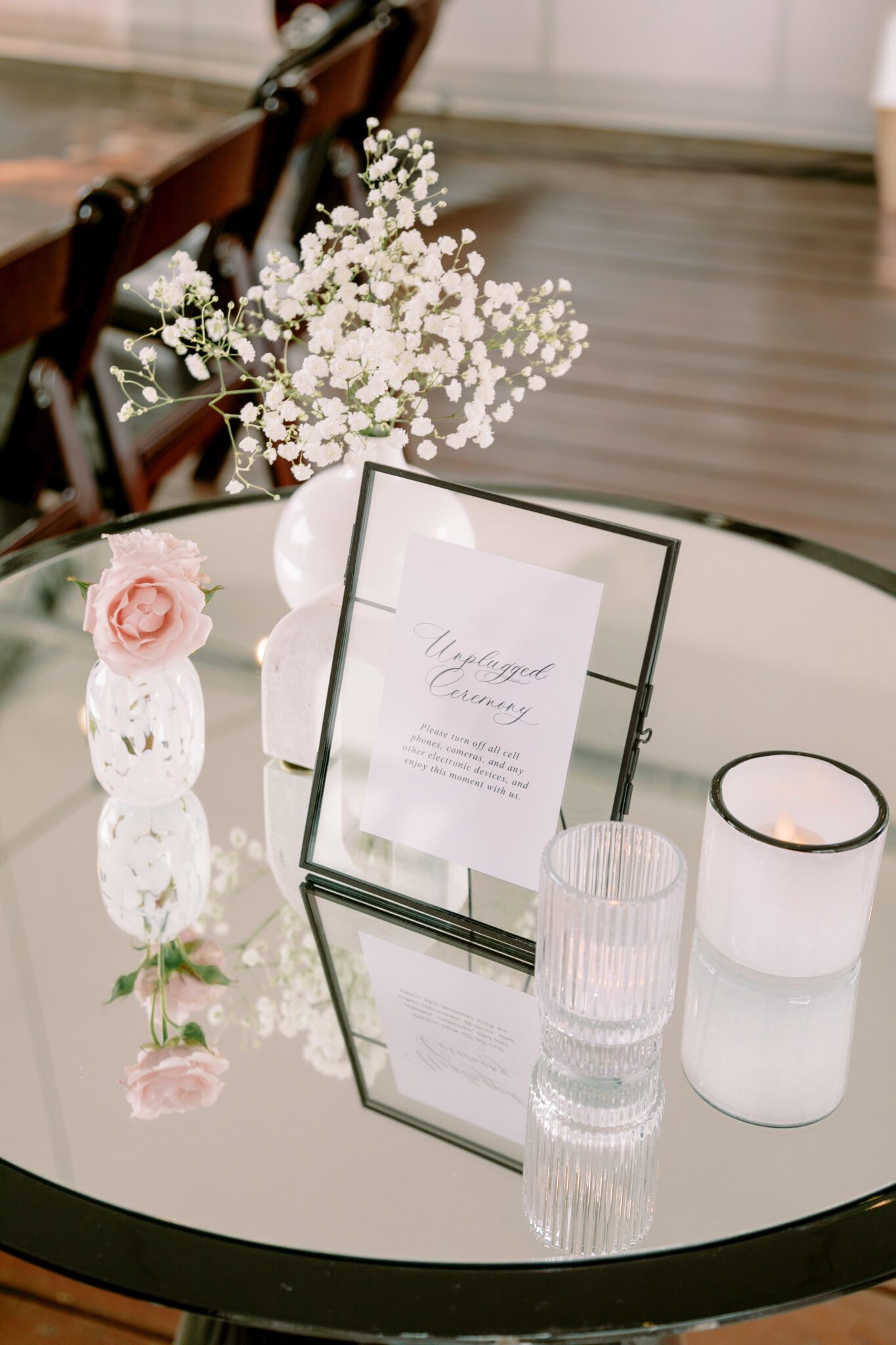 Wedding ceremony setup at Stewart Creek Golf Course in Canmore, Alberta. White, pink and black colour scheme. Mountain wedding ceremony. Unplugged ceremony sign. 