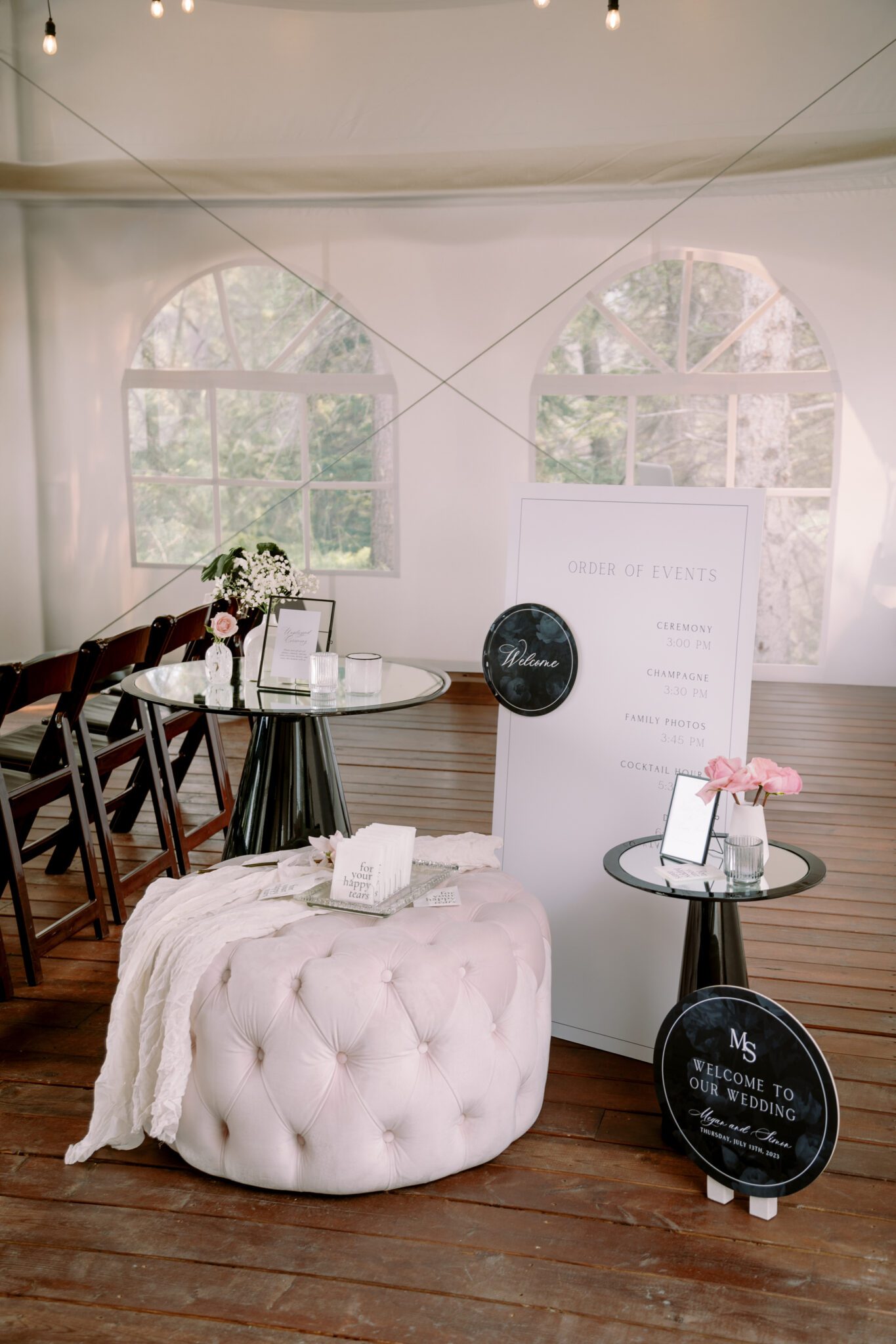 Wedding ceremony setup at Stewart Creek Golf Course in Canmore, Alberta. White, pink and black colour scheme. Mountain wedding ceremony. Wedding ceremony  welcome sign