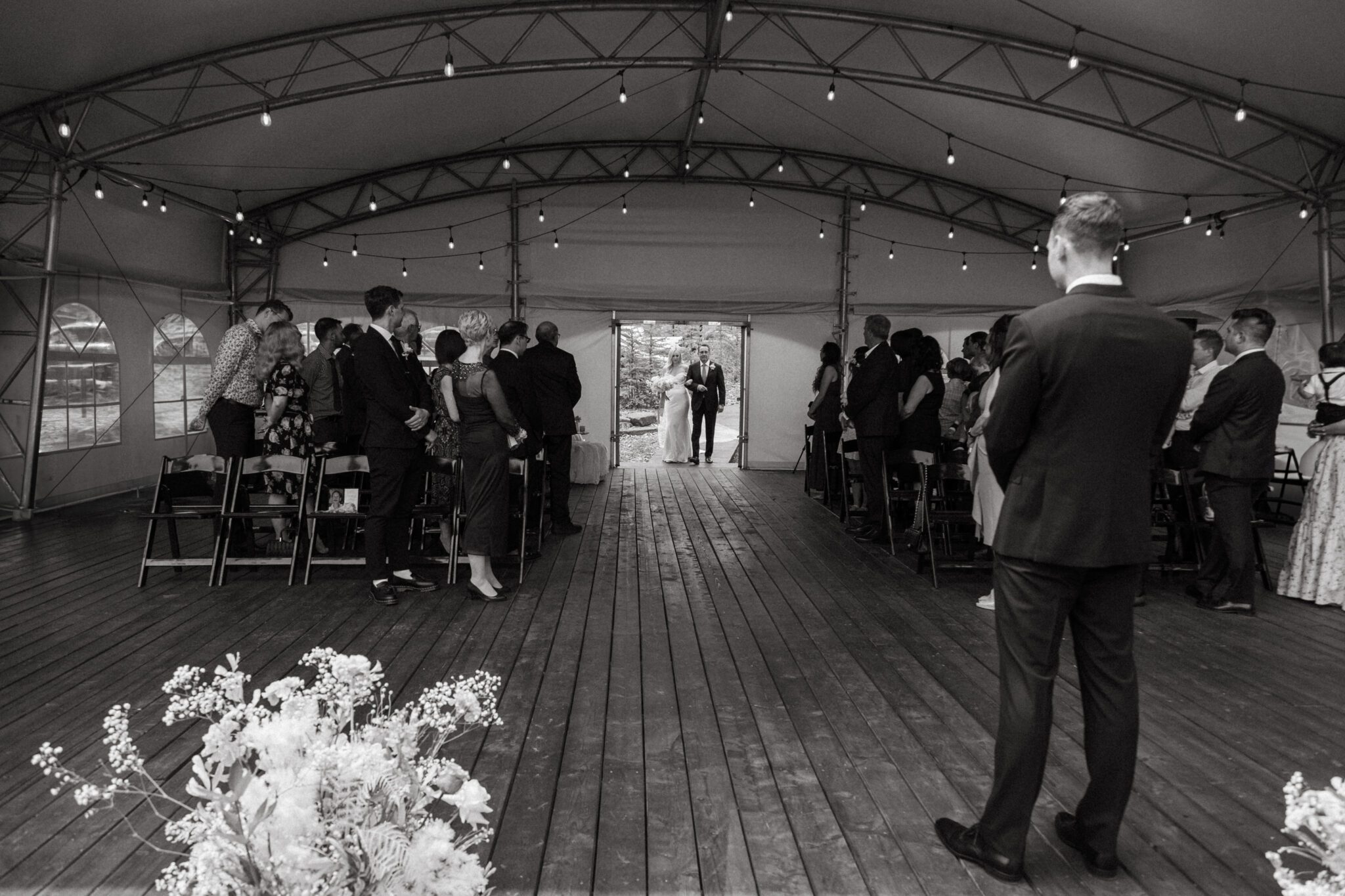 Bride entering wedding ceremony setup at Stewart Creek Golf Course in Canmore, Alberta.  Mountain wedding ceremony. 