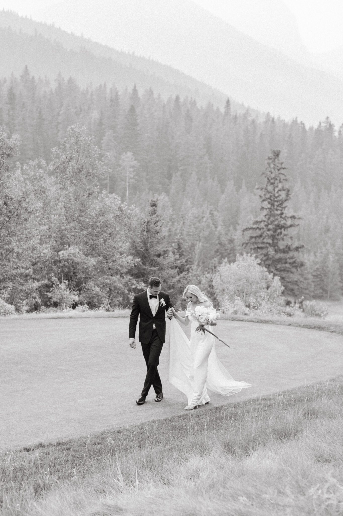 Bride and groom embracing during Steward Creek Golf Course wedding in Canmore, Alberta. Spring wedding inspiration. 