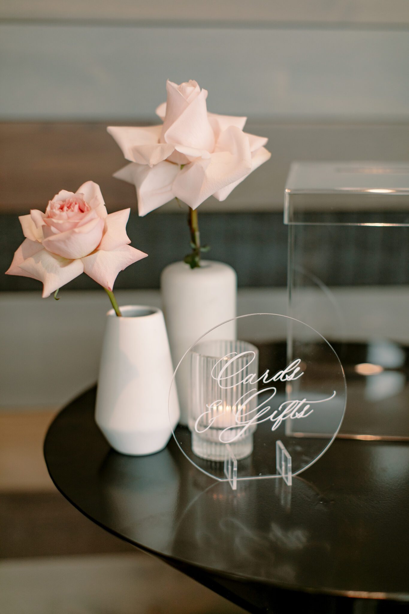 Wedding reception signage at The Sensory in Canmore, Alberta. Black and white wedding signs surrounded by pink and white florals.
