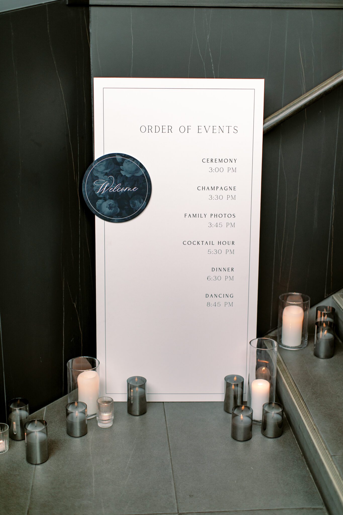 Wedding reception signage at The Sensory in Canmore, Alberta. Black and white wedding signs surrounded by candles.