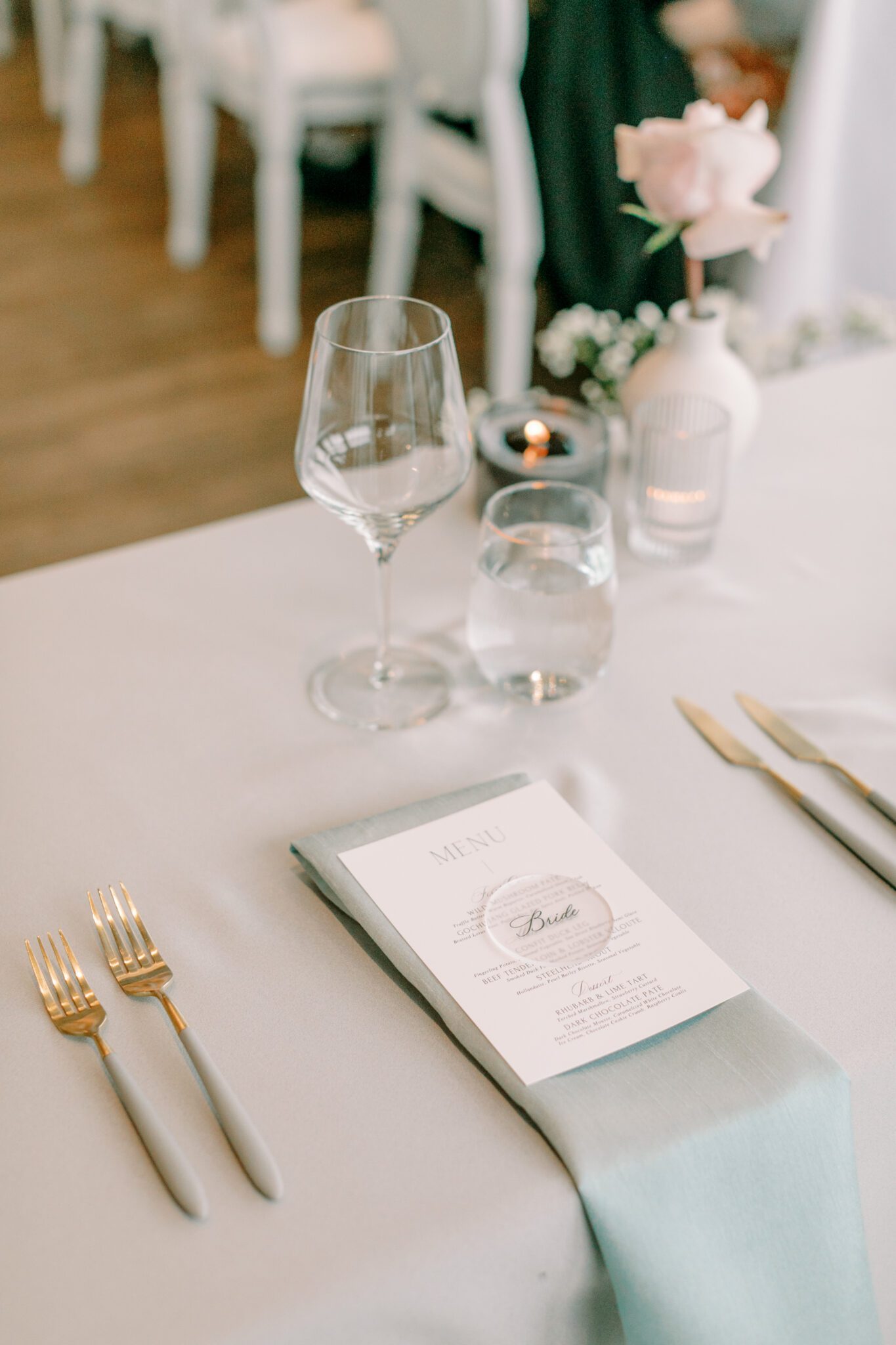 Modern and chic wedding reception at The Sensory in Canmore, Alberta.  Long tables with white linens, blue napkins, and pink floral centrepieces
