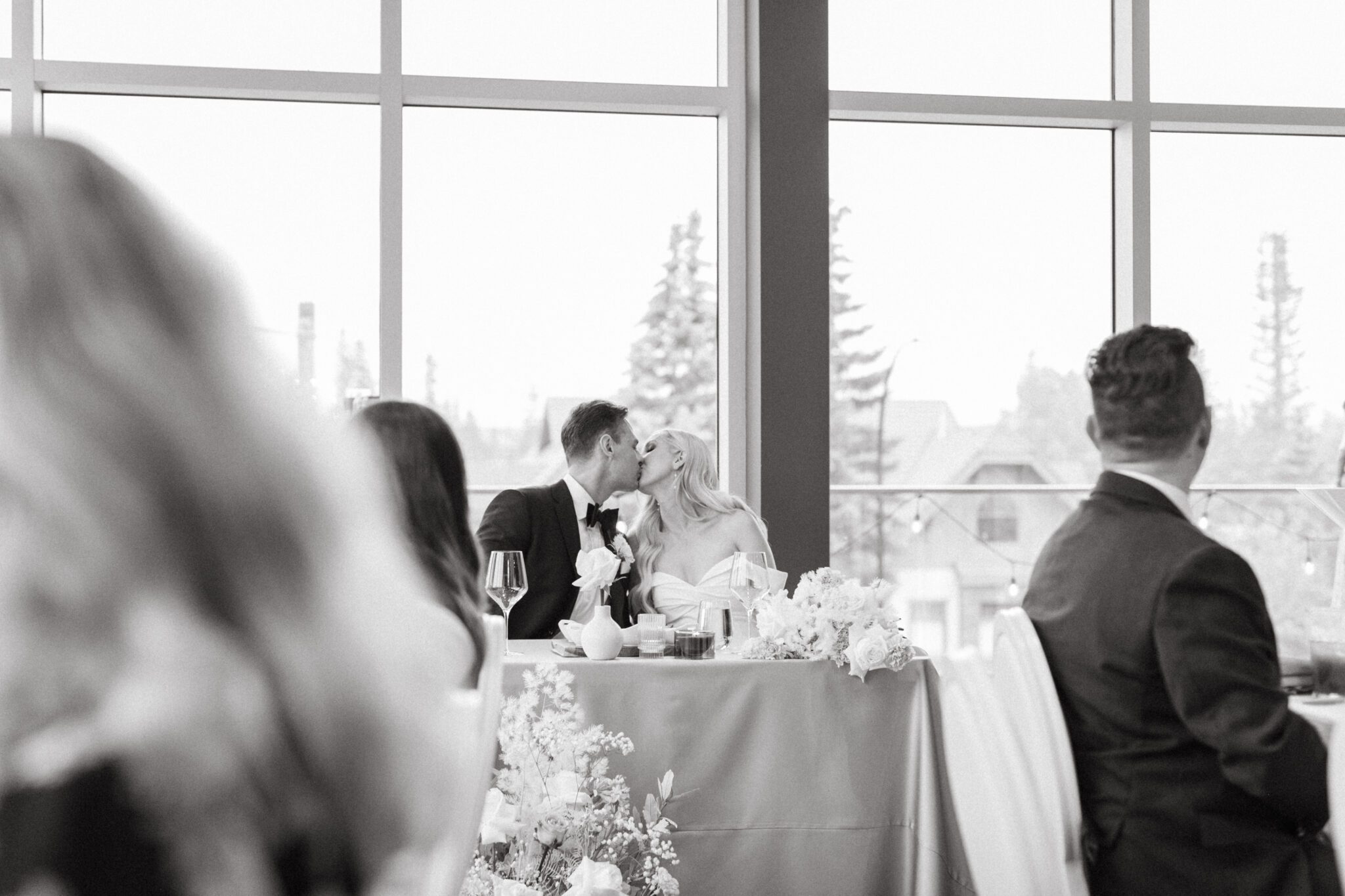 Bride and groom kissing during a wedding reception at The Sensory  in Canmore, Alberta. 