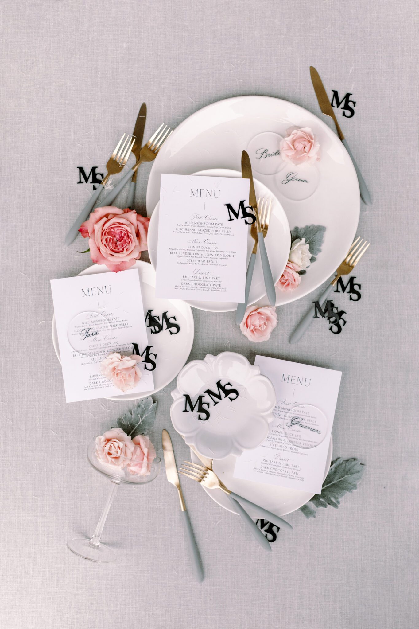 Custom wedding reception menu created by Rebekah Brontë Designs, pink roses, and custom monogram champagne glass toppers.