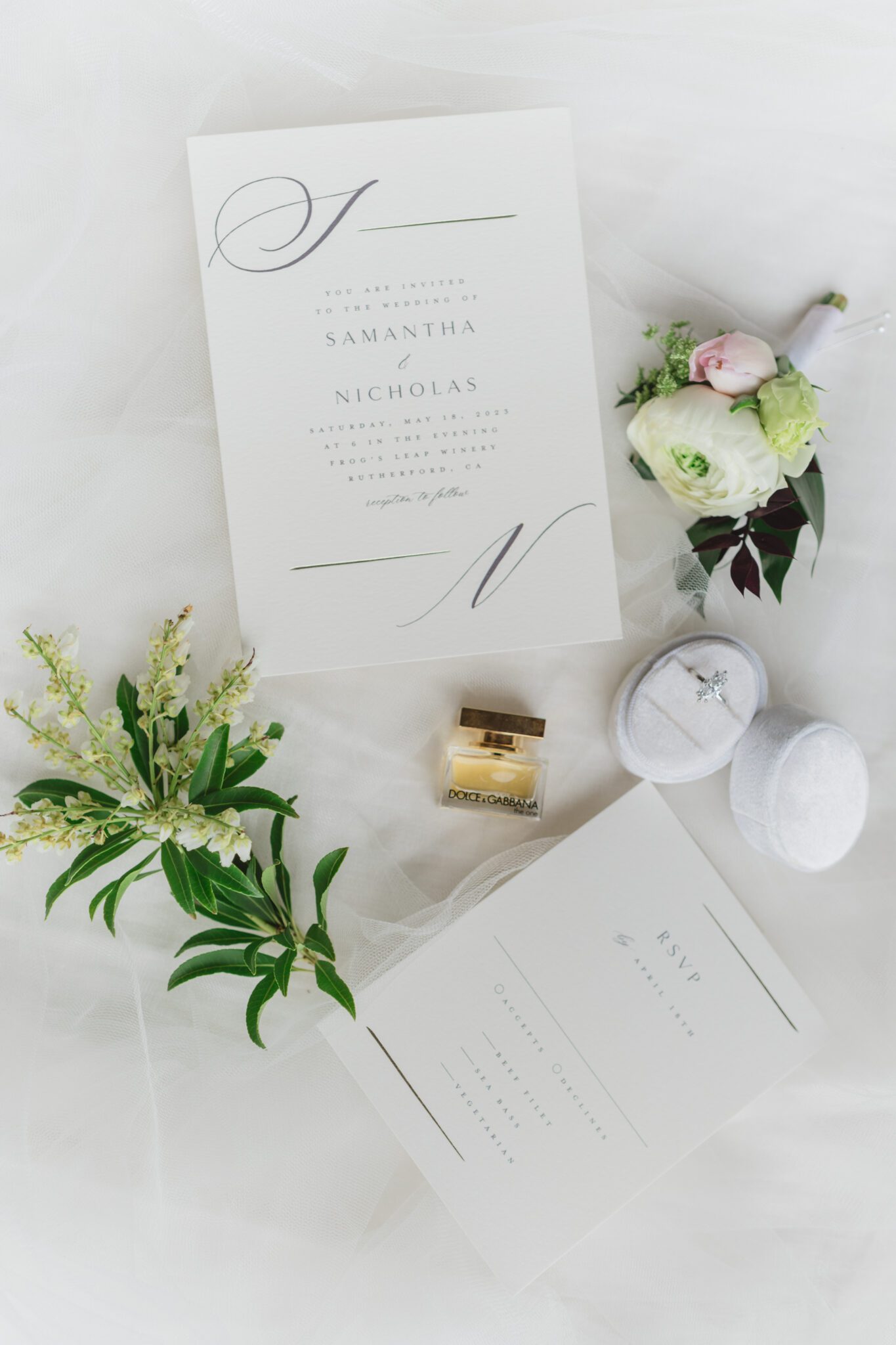 Wedding invitation paper suite featuring classic and elegant white invitation, white velvet ring box, gold perfume bottle, and handcrafted boutonniere by Yours Truly Floral Studio in Chilliwack, British Columbia. 