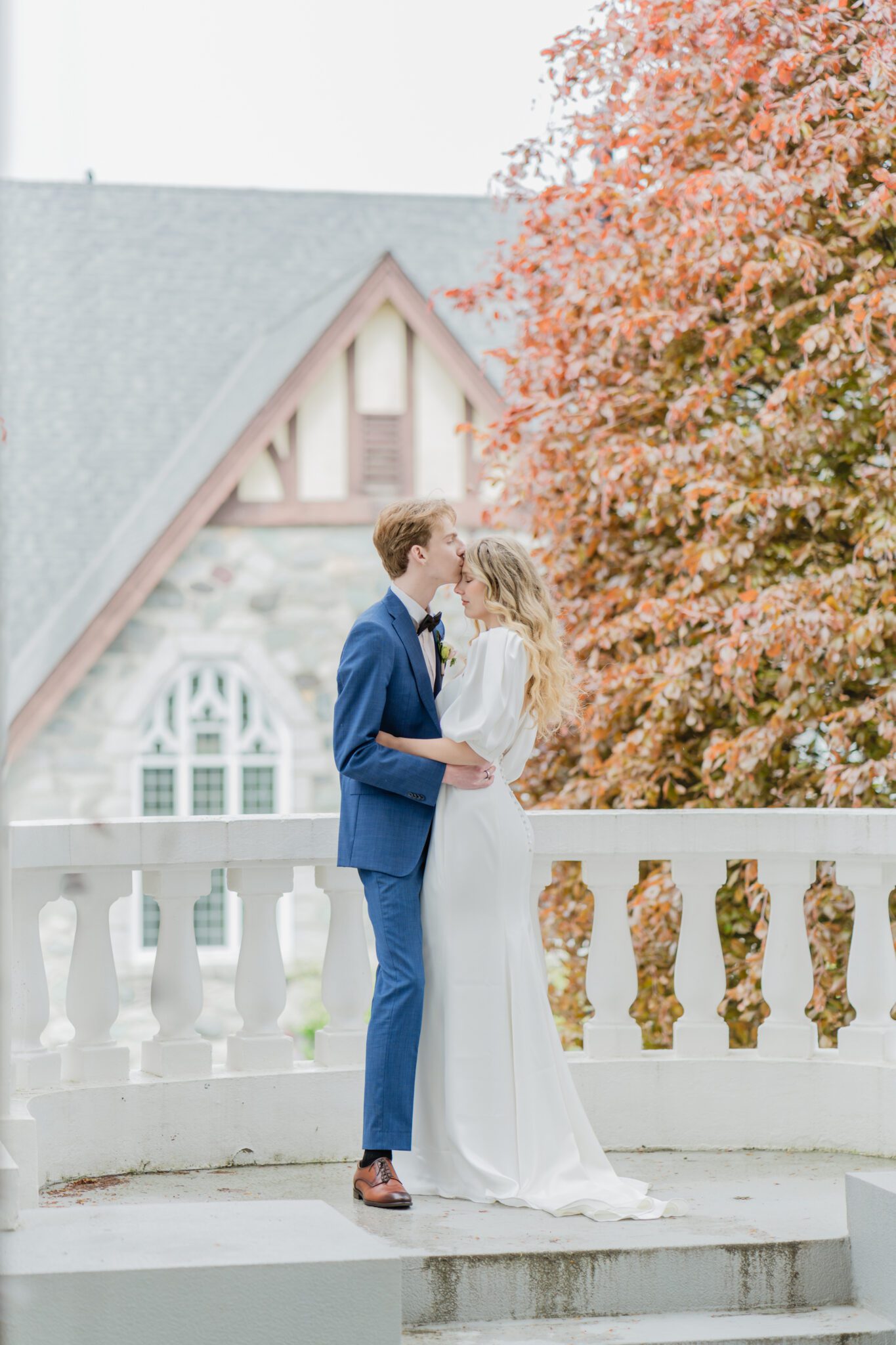 Bride and groom embracing at a timeless elegant wedding at Chilliwack Museum. Featuring the museum's classical architecture featuring pillars, arch windows and a grand staircase.