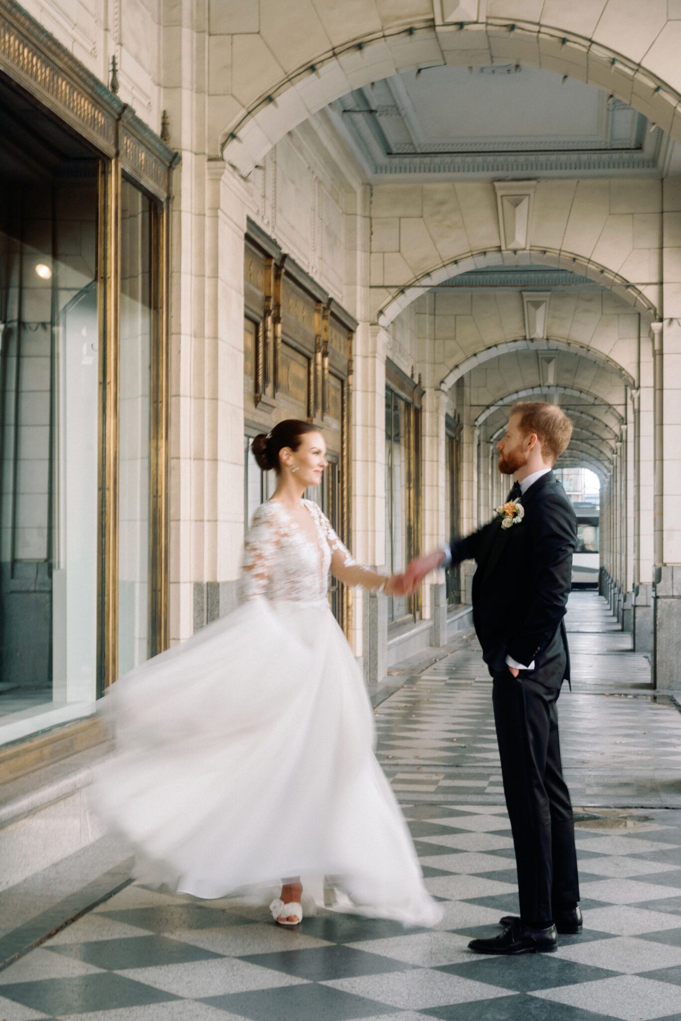 Groom twirling bride in downtown Calgary, Alberta perfect for a romantic wedding portrait.