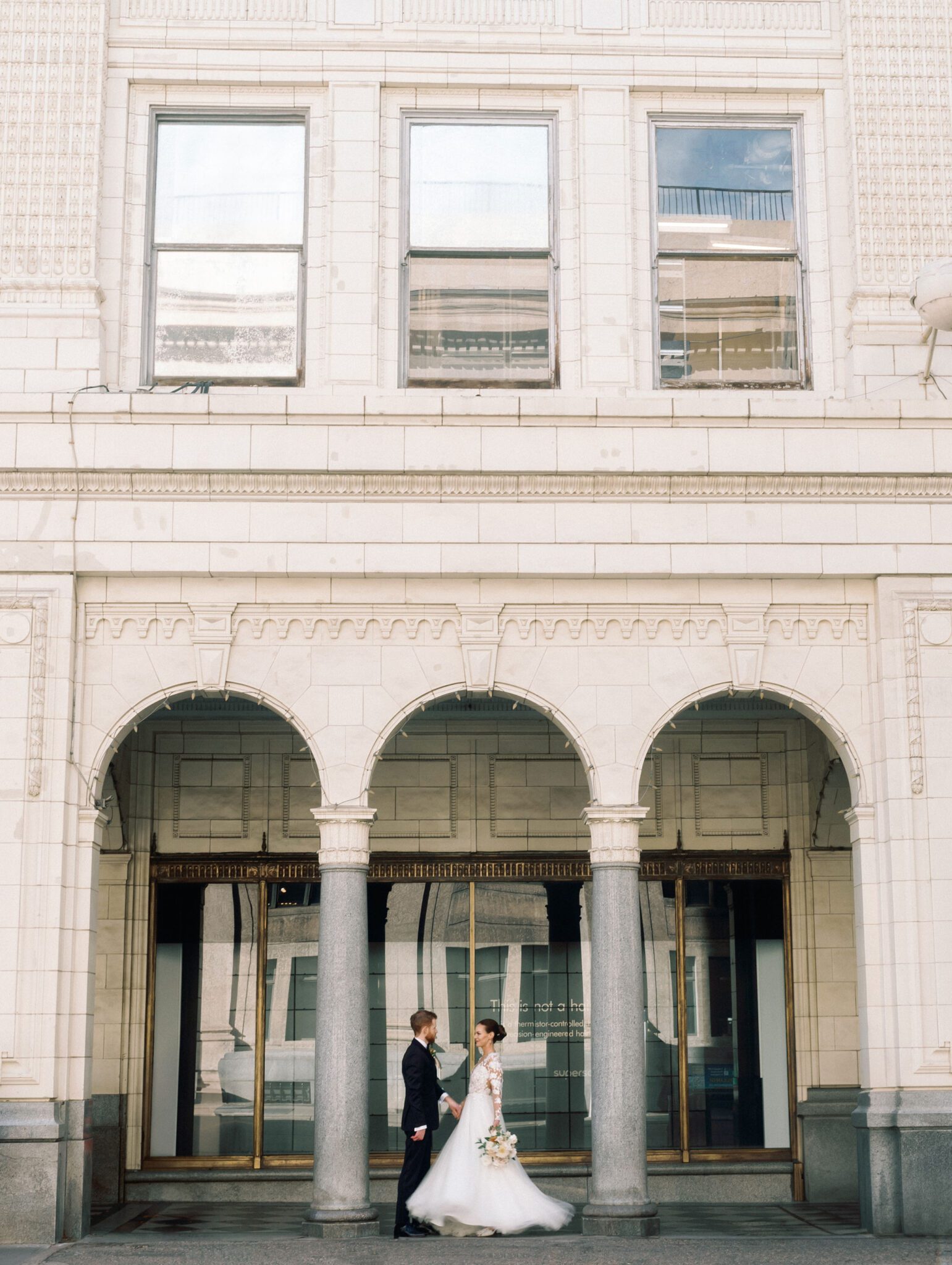 Groom twirling bride in downtown Calgary, Alberta perfect for a romantic wedding portrait.