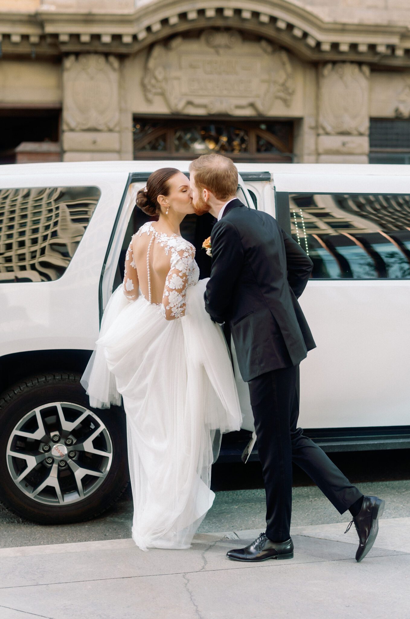 Groom and bride getting into limo in downtown Calgary, Alberta perfect for a romantic wedding portrait.