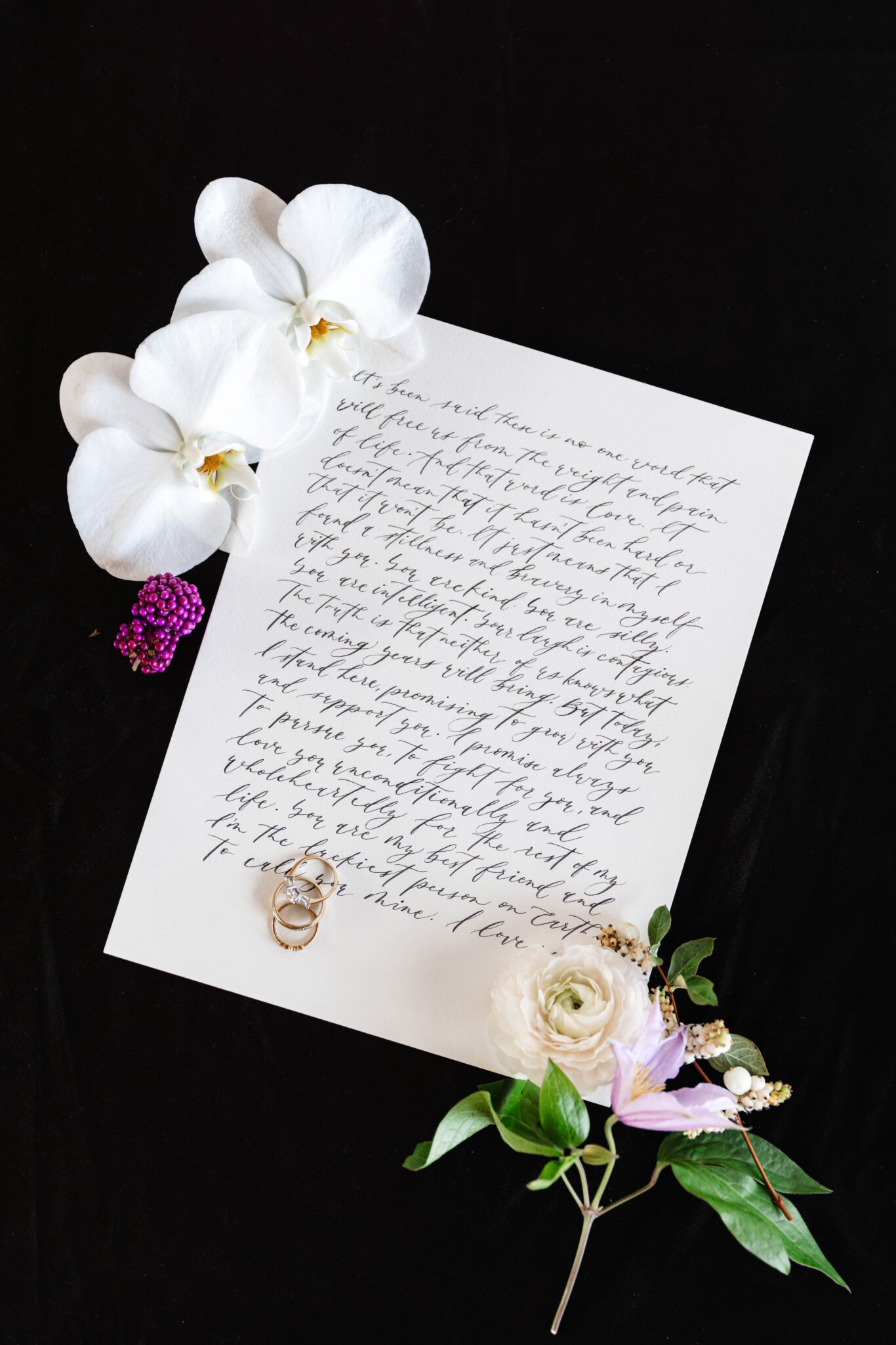 Purple garden wedding inspiration. Custom calligraphy vows handwritten by Written by Winh. Surrounded by white orchids and purple florals.