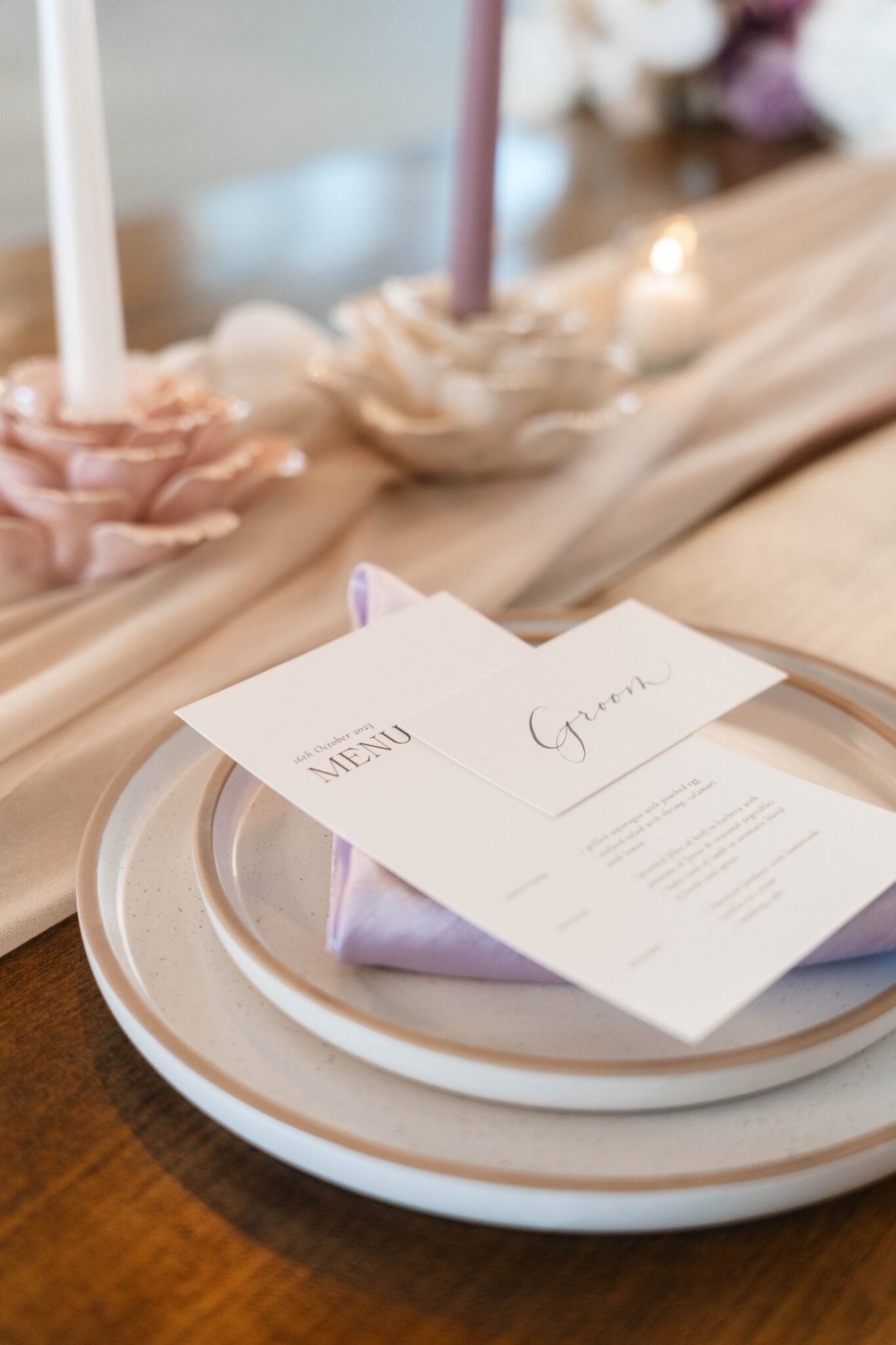 Reception tablescape at The Pendennis featuring lush purple garden party inspired wedding florals, purple table runner, floral candle holder.