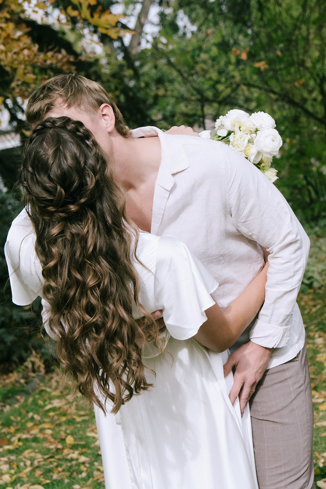 Bride and groom share their first kiss at cottage core inspired wedding ceremony at The Norland Historic Estate in Southern Alberta.