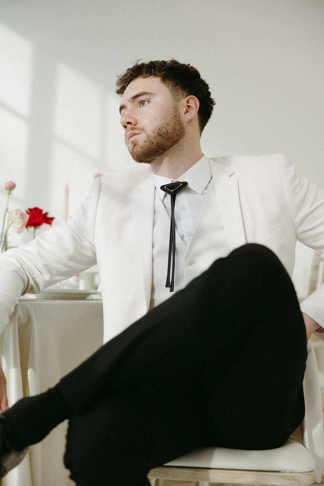 Groom wearing white and black suit styled with modern minimalist elements , captured by Zoe Snooks Photography.