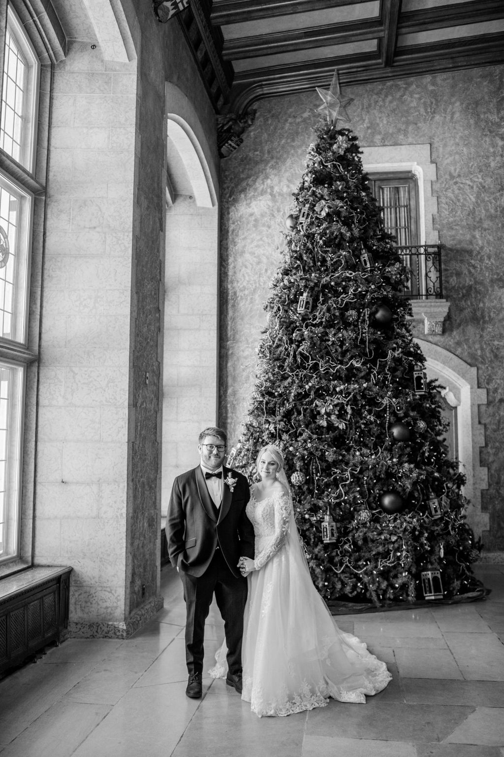 Bride and groom share a quiet moment inside the grand interior of Fairmont Banff Springs, surrounded by elegant architecture and soft candlelight. Winter Wedding Portraits at Fairmont Banff Springs.