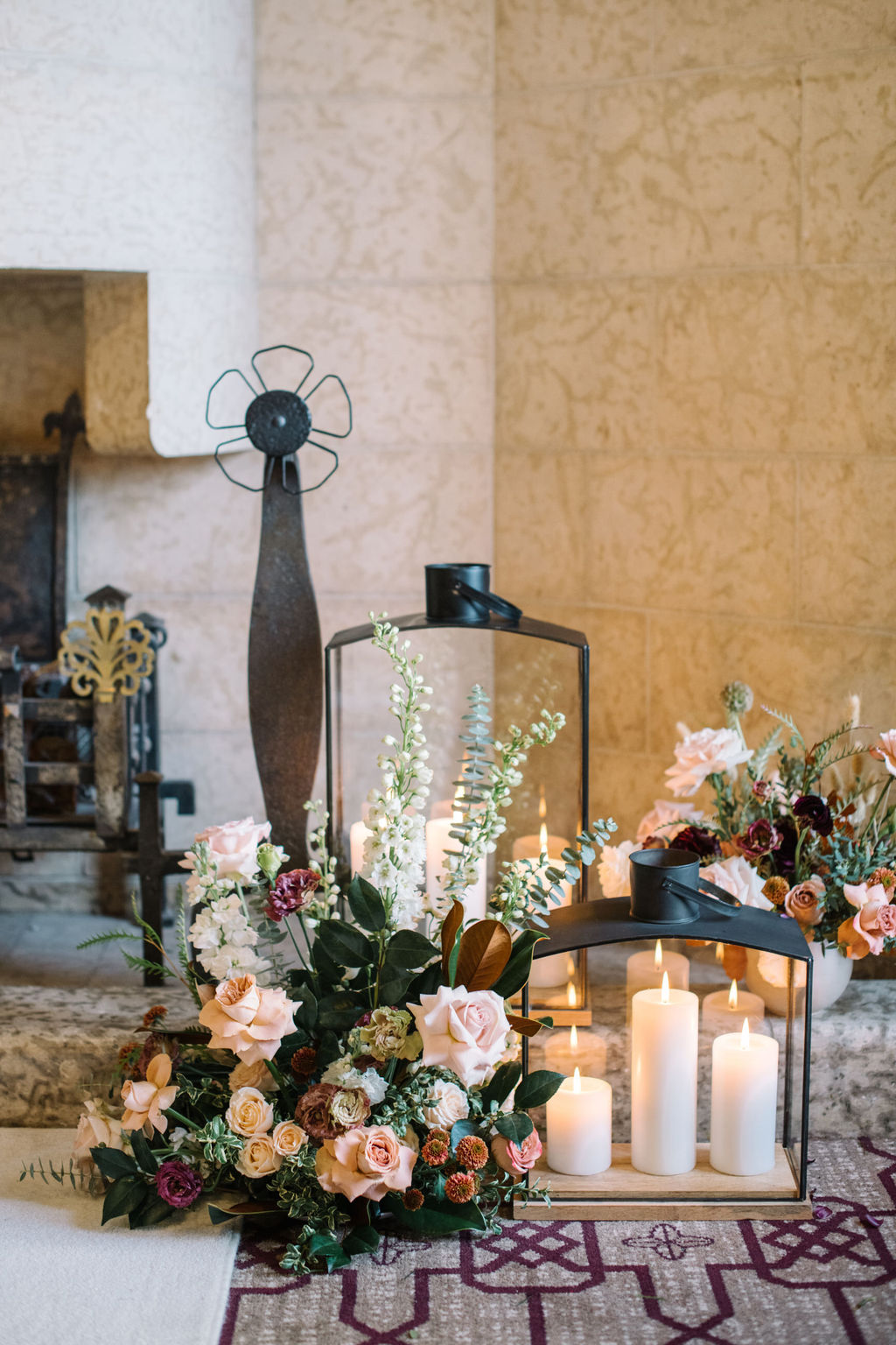 Lanterns, candles and lush winter florals line the aisle, creating a romantic and intimate setting for the cozy wedding ceremony in the Angus Room at Fairmont Banff Springs,
