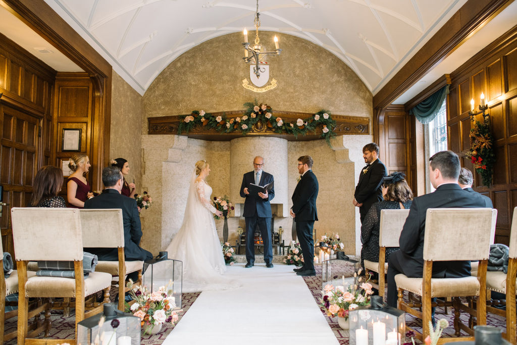 The couple exchanges vows in front of their closest loved ones in the cozy and historic Angus Room at Fairmont Banff Springs.
