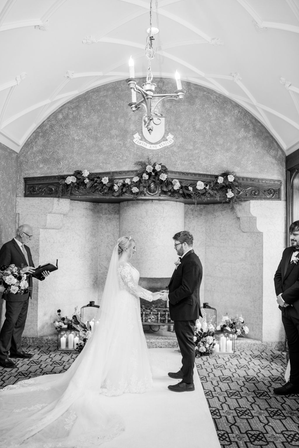 The couple exchanges vows in front of their closest loved ones in the cozy and historic Angus Room at Fairmont Banff Springs.