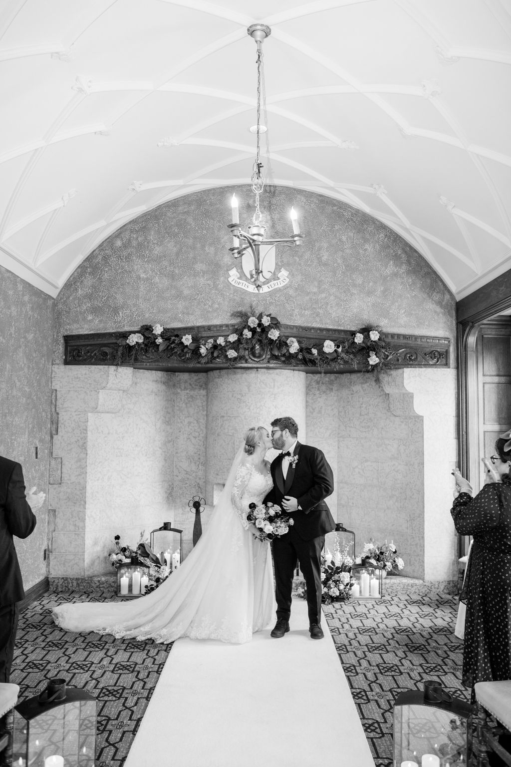 Couple's first kiss during their ceremony in the cozy and historic Angus Room at Fairmont Banff Springs.