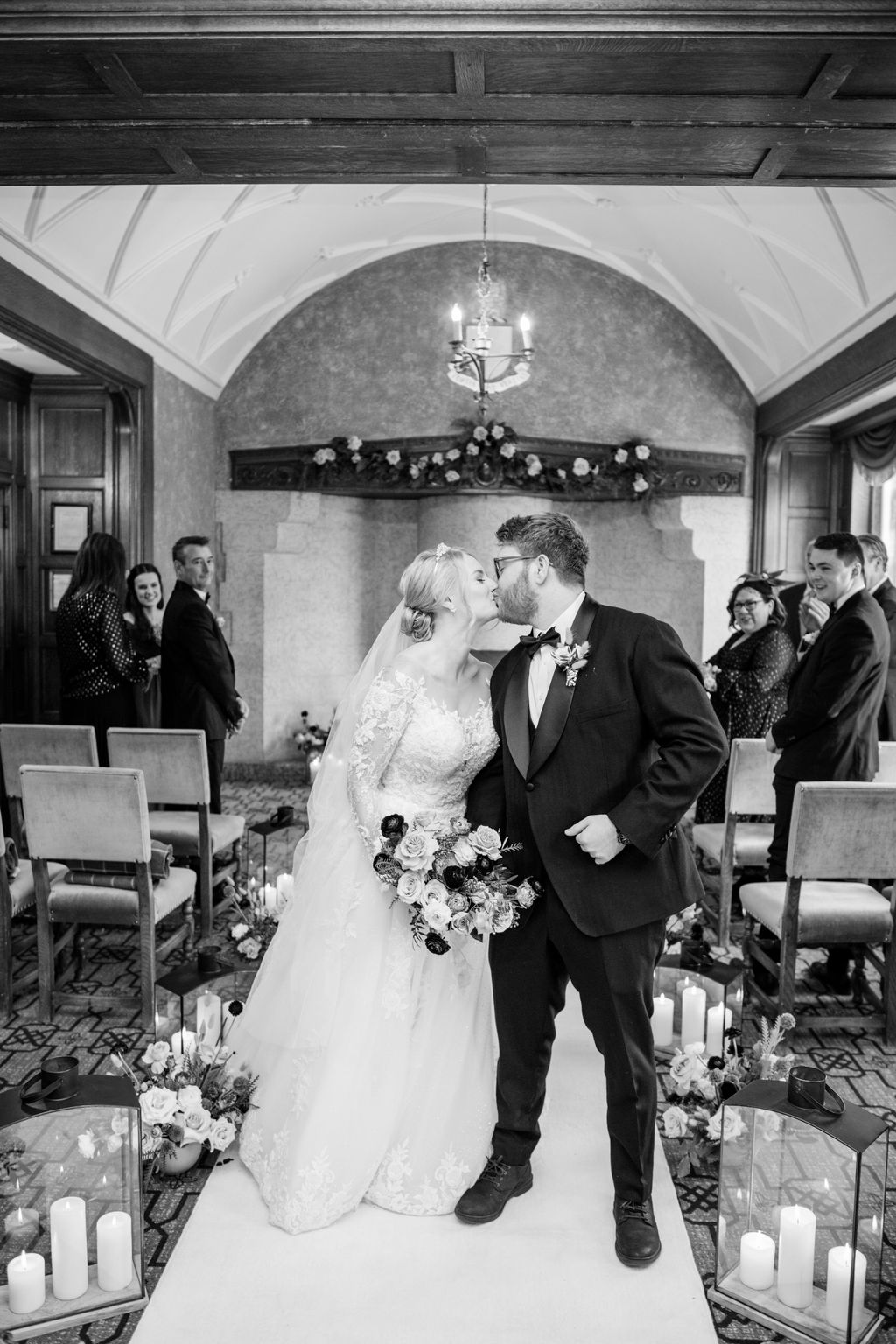 Bride. andgroom kiss during their ceremony in the cozy and historic Angus Room at Fairmont Banff Springs.