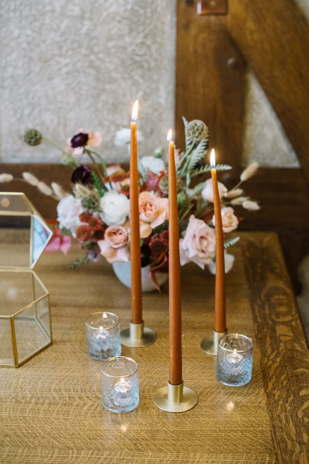 Cozy winter reception styled with rich hues and elegant decor for an intimate wedding celebration. Set of 3 taper candles.