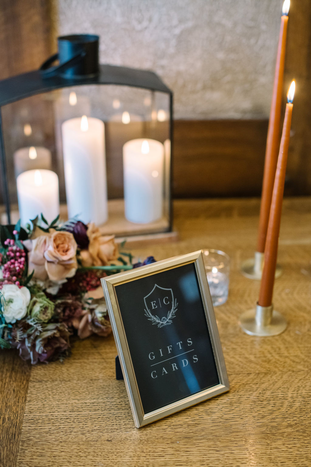 Cards and gifts signage. Cozy winter reception styled with rich hues and elegant decor for an intimate wedding celebration.