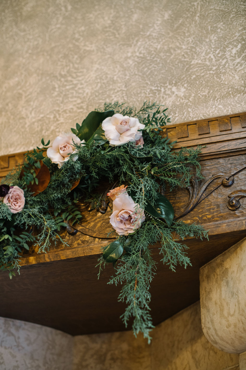 Winter wedding ceremony with greenery in the Angus Room at Fairmont Banff Springs,