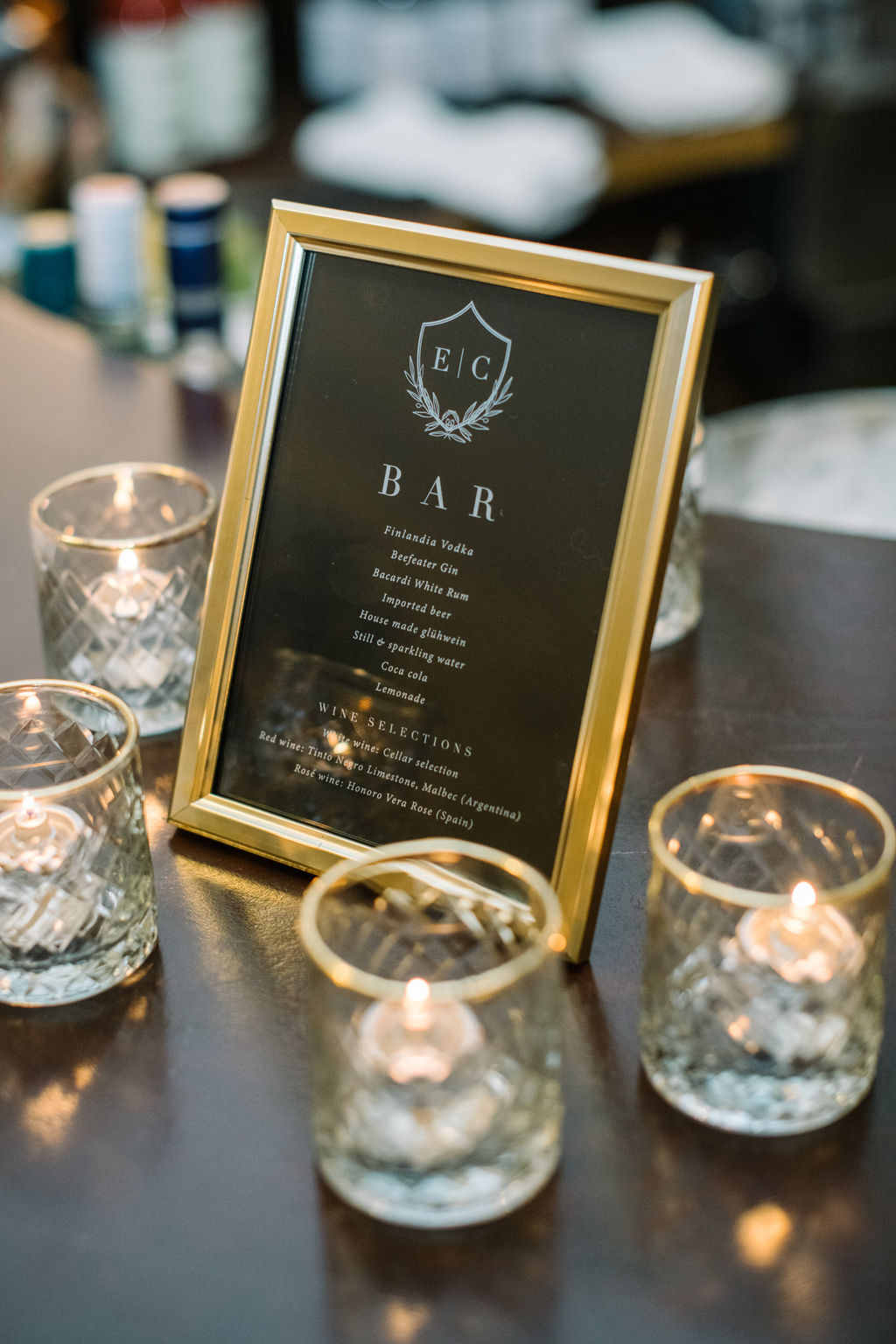 Elegant Black Bar Signage. Cozy winter reception in the Angus Room at Fairmont Banff Springs, styled with rich hues and elegant decor for an intimate wedding celebration.