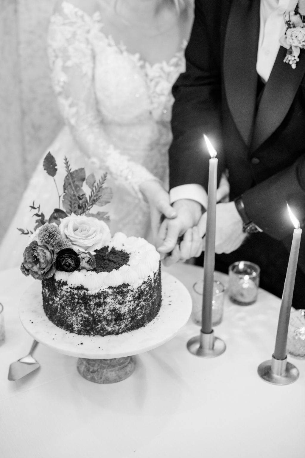 Small burgundy wedding cake, bride and groom cake cutting. Cozy winter reception in the Angus Room at Fairmont Banff Springs, styled with rich hues and elegant decor for an intimate wedding celebration.